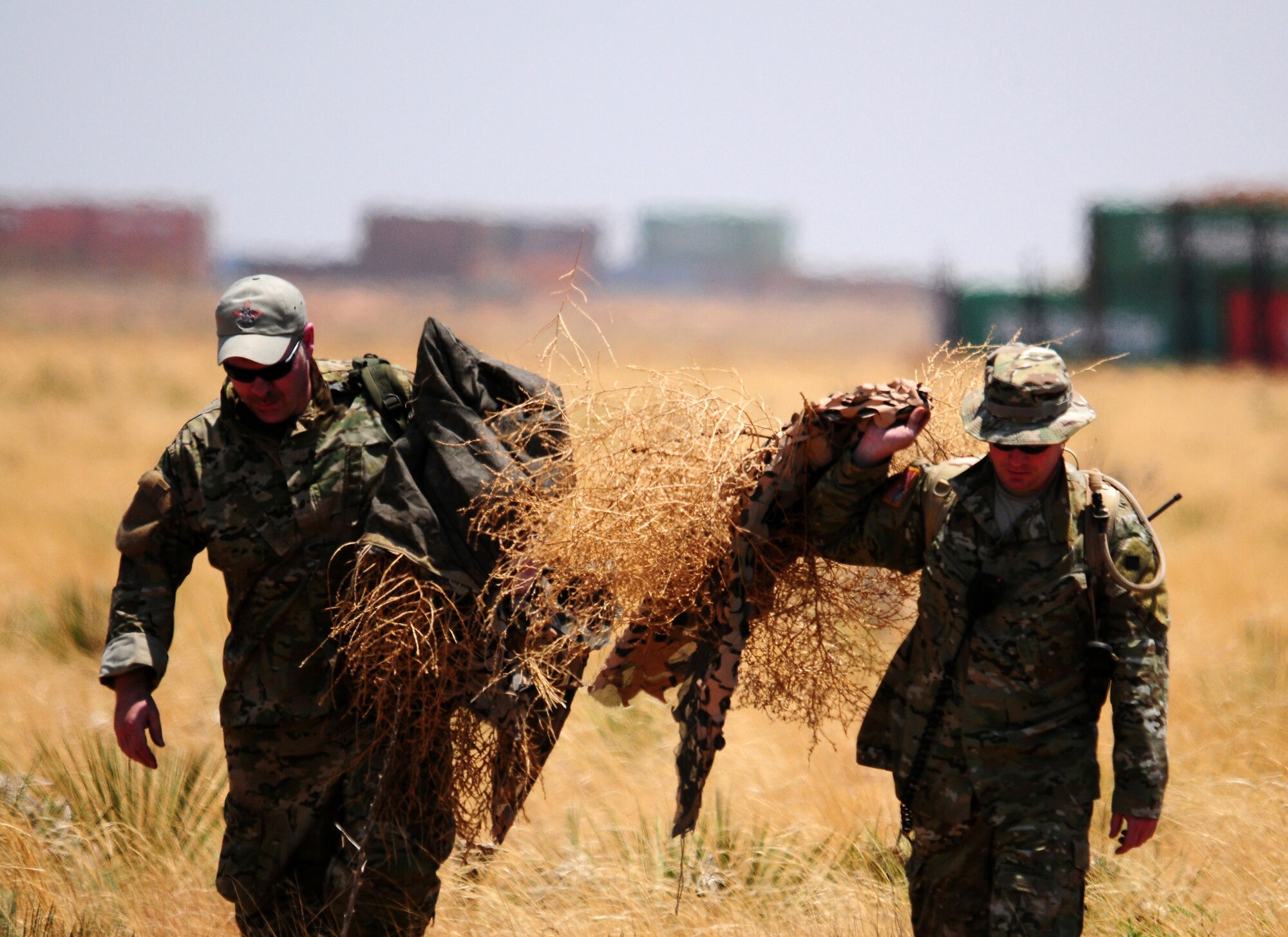 Scenario participants simulating the role of Joint Terminal Air Controllers reveal themselves from a hidden location at the conclusion of an aerial and ground demonstration for around 600 spectators at the 27th Special Operations Wing Capabilities Exercise, June 4, 2011, at Melrose Air Force Range. The CAPEX is an annual exhibition of the 27 SOW's many special operations aircraft and missions for Cannon Airmen and their families. (U.S. Air Force photo by Staff Sgt. Nicholas Phelps)(RELEASED)