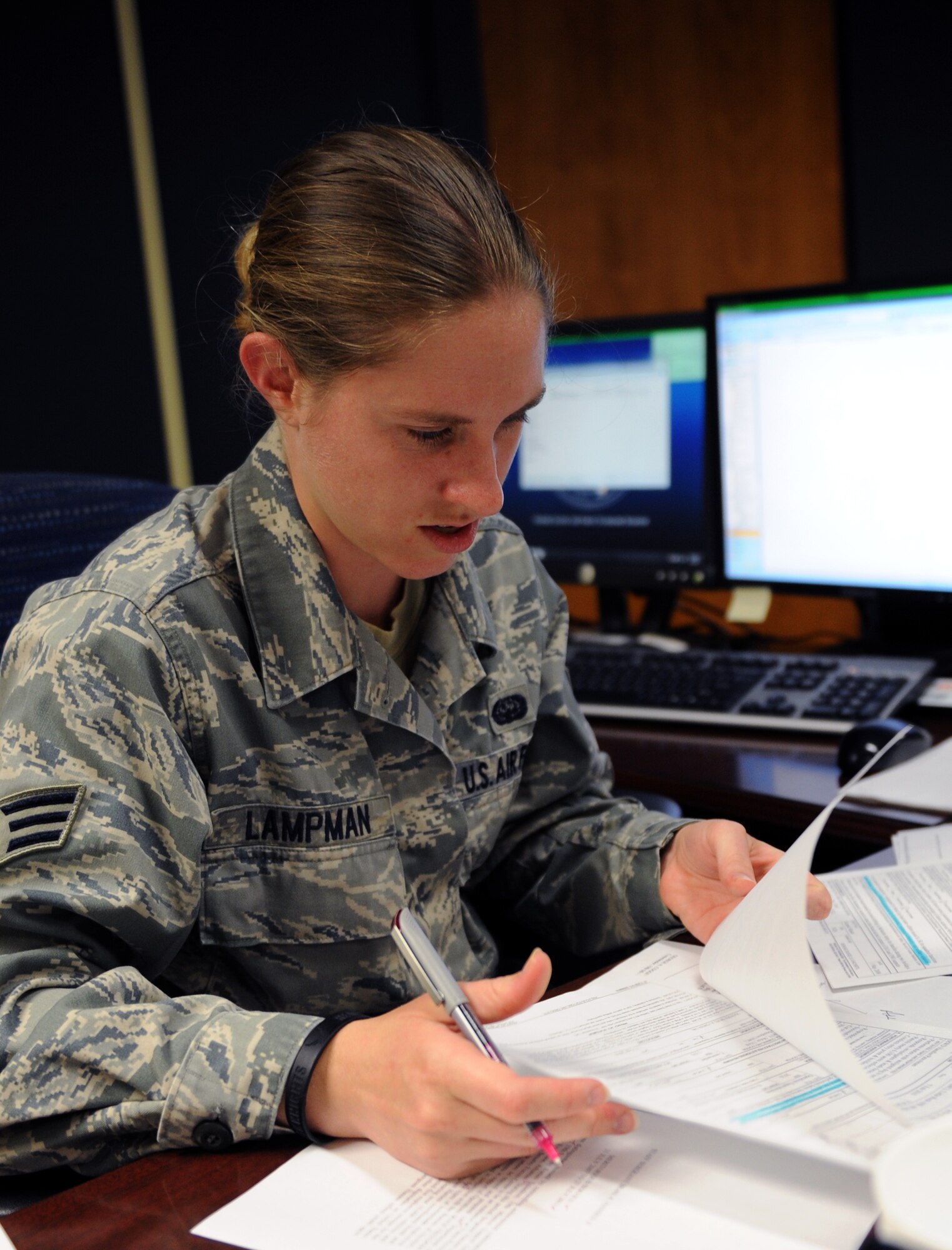 Senior Airman Shelly Lampman, a 19th Mission Support Group functional area records manager, reviews paperwork June 6, 2011, at Little Rock Air Force Base, Ark. The Punta Gorda, Fla., native conducted weekly file plan staff assistance visits on six squadrons with 48 accounts in less than four months. (U.S. Air Force photo /Airman 1st Class Rusty Frank)