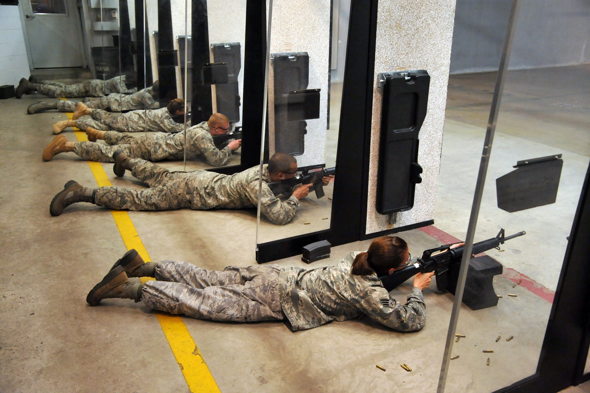 SEYMOUR JOHNSON AIR FORCE BASE, N.C.- Airmen aim their weapons down range and prepare to fire during a combat arms training and maintenance course (CATM) here, June 8, 2011. CATM personnel are responsible for training all Seymour Johnson Airmen on small arms weapons in preparation of deployments or upcoming departures to a new base. (U.S. Air Force photo/Senior Airman Whitney Lambert)(RELEASED)