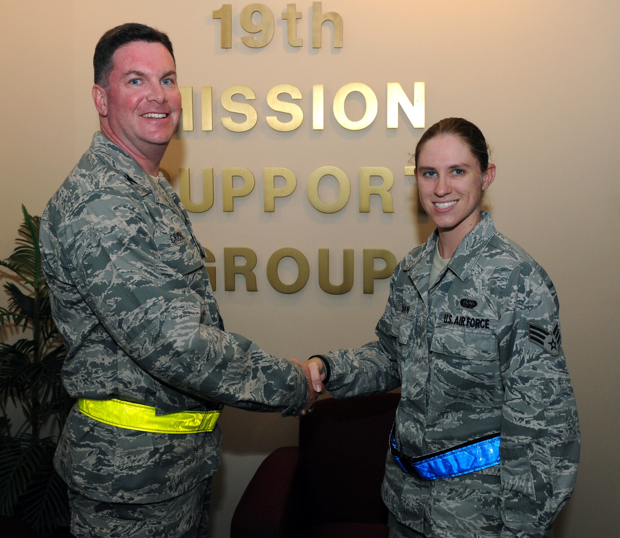 Col. Thomas Crimmins, 19th Airlift Wing vice commander, presents a coin June 6, 2011, to Senior Airman Shelly Lampman, a 19th Mission Support Group functional area records manager, for her selection as the Combat Airlifter of the Week at Little Rock Air Force Base, Ark. Airman Lampman was a pivotal player in the 19th MSG's Group Control Center during tornado recovery operations. (U.S. Air Force photo/ Airman 1st Class Rusty Frank)