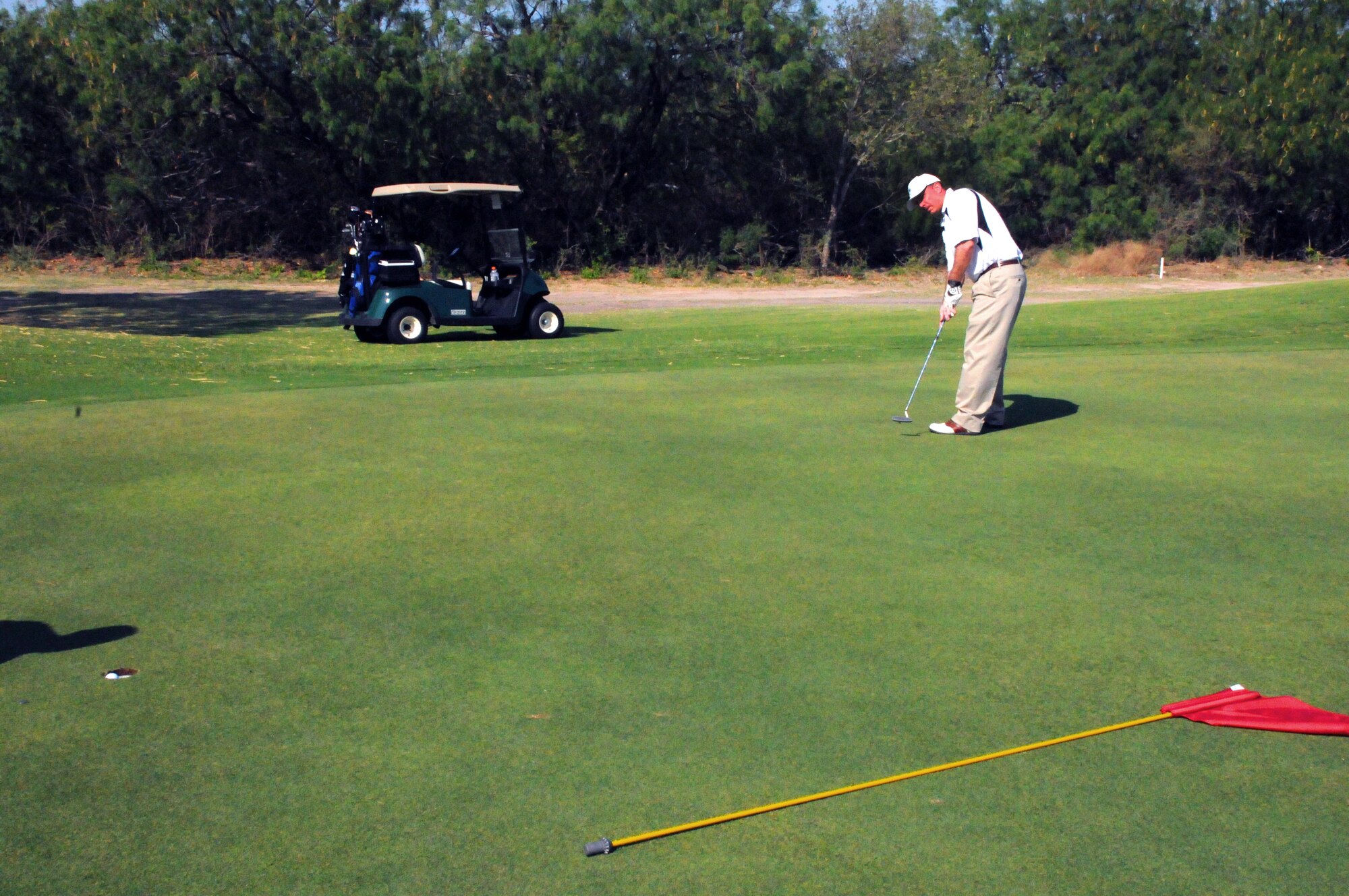 LAUGHLIN AIR FORCE BASE, Texas -- Col. Michael Frankel, 47th Flying Training Wing commander, smoothly taps a long birdie attempt during a Chiefs and Shirts versus Commanders Golf Tournament here recently. (U.S. Air Force photo by Senior Airman Scott Saldukas)