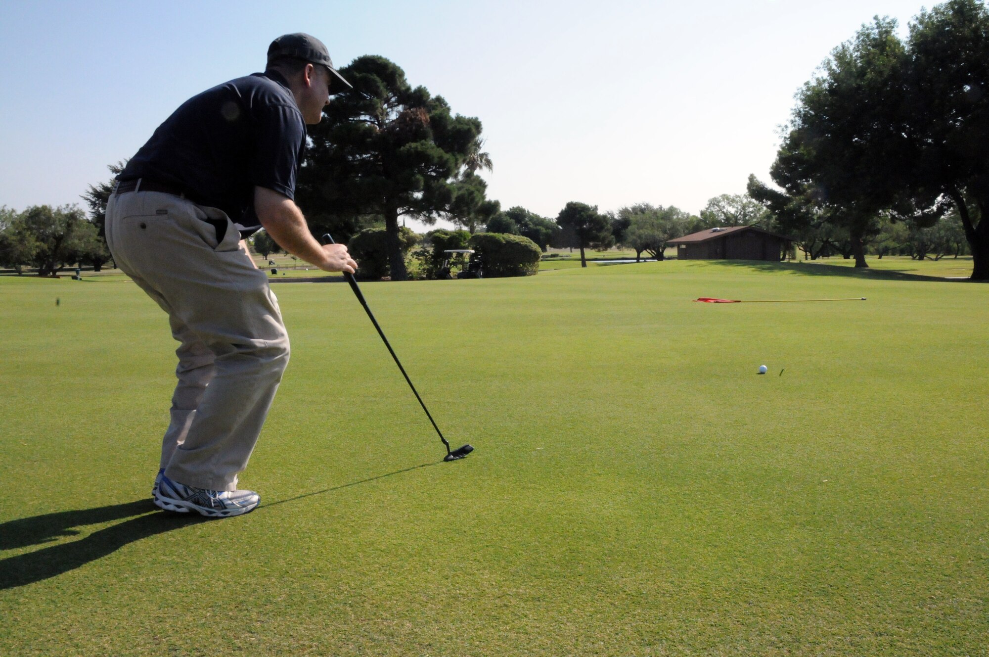 LAUGHLIN AIR FORCE BASE, Texas --  (Capt.) Brian Nierman, 47th Flying Training Wing chaplain, sets up for a birdie putt during a Chiefs and Shirts versus Commanders Golf Tournament here recently. (U.S. Air Force photo by Senior Airman Scott Saldukas)
