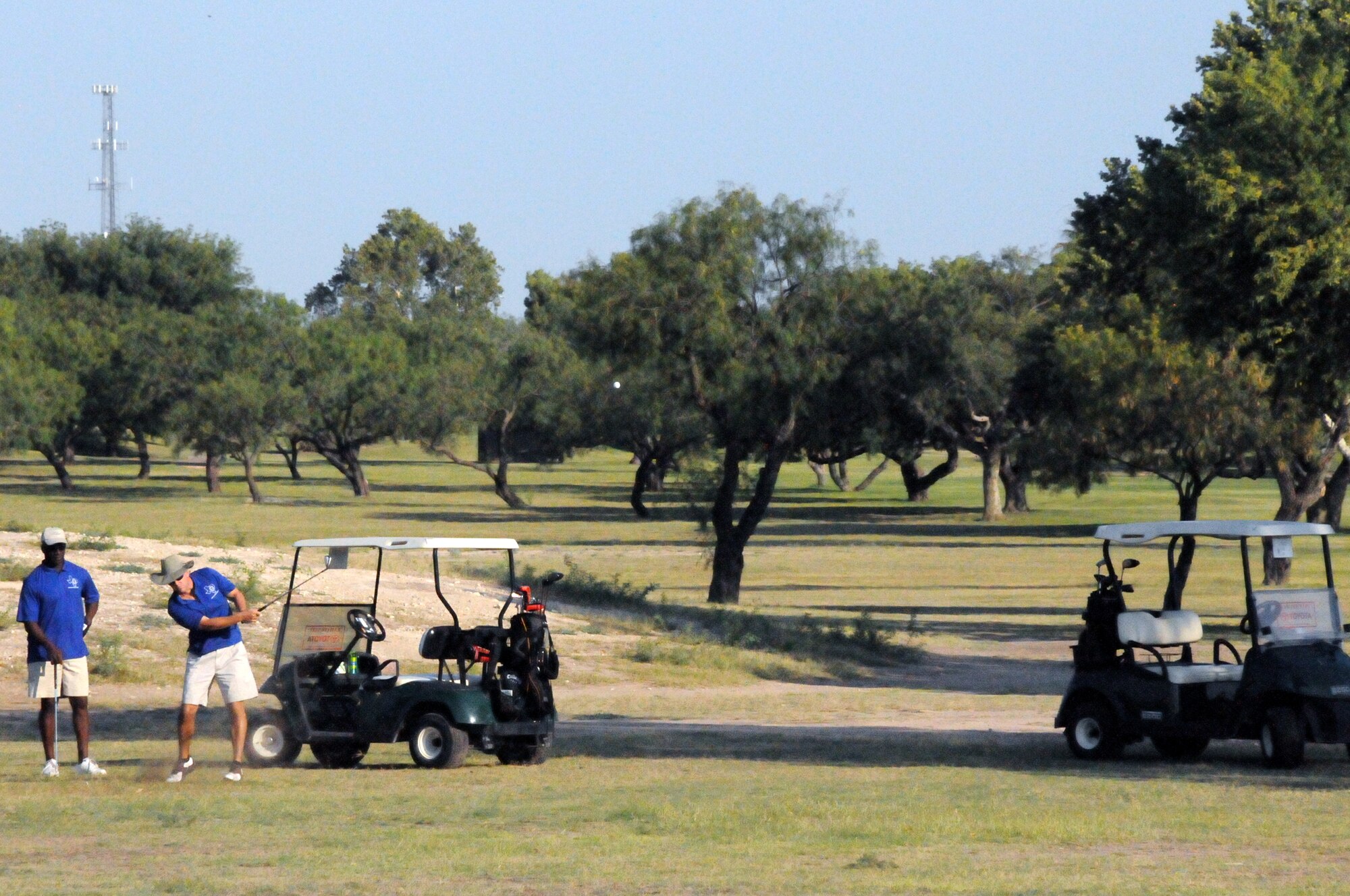 LAUGHLIN AIR FORCE BASE, Texas -- Chief Master Sgt. Michael King, 47th Mission Support Group, watches as Chief Master Sgt. Dean Ferris, 47th Operations Group, takes a shot towards the green during a Chiefs and Shirts versus Commanders Golf Tournament here recently. (U.S. Air Force photo by Senior Airman Scott Saldukas)

