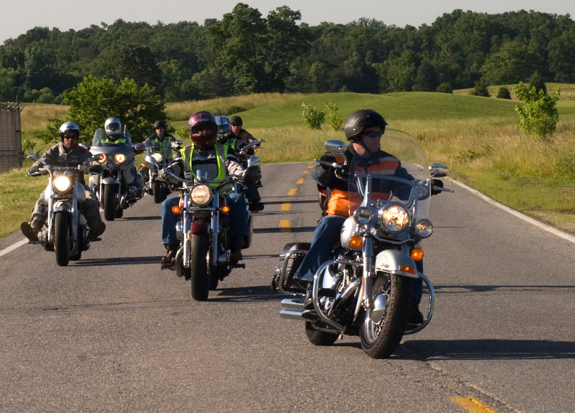 Terry A. Yonkers, Assistant Secretary of the Air Force for installations, environment and logistics, right, is followed by Green Knights Military Motorcycle Club International members during a motorcycle safety public service announcement video recording at Joint Base Andrews on June 2. The Green Knights work hand in hand with the 11th Wing Safety Office and Joint Base Andrews Security Forces members to help riders follow regulations set forth by the Federal, State, and local bases. (Photo by Bobby Jones) 