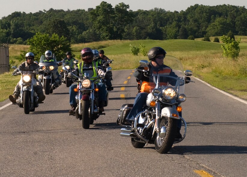 Terry A. Yonkers, Assistant Secretary of the Air Force for installations, environment and logistics, right, is followed by Green Knights Military Motorcycle Club International members during a motorcycle safety public service announcement video recording at Joint Base Andrews on June 2. The Green Knights work hand in hand with the 11th Wing Safety Office and Joint Base Andrews Security Forces members to help riders follow regulations set forth by the Federal, State, and local bases. (Photo by Bobby Jones) 