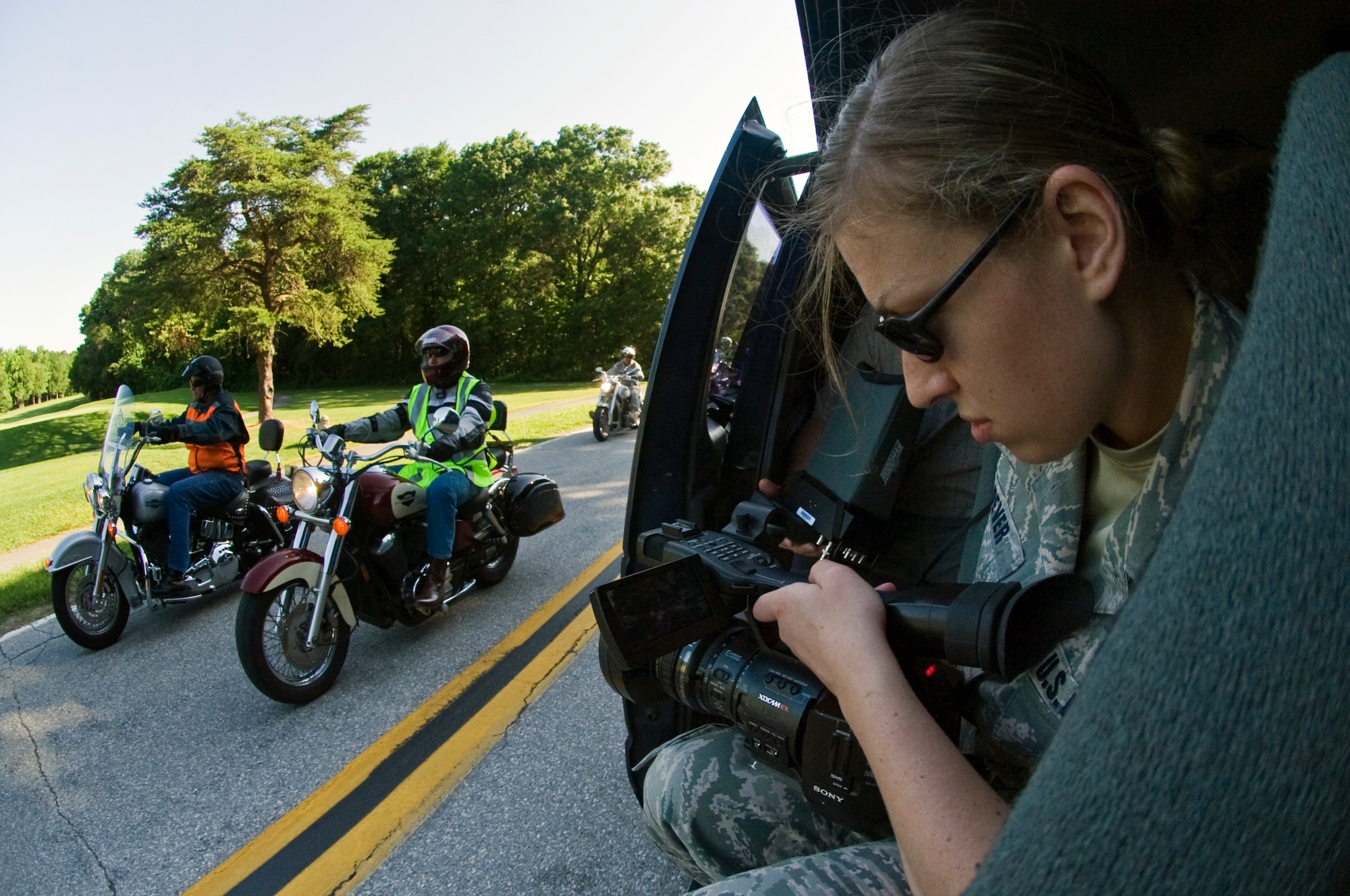 Staff Sgt. Mary Dever, Air Force Television Services multimedia producer, shoots digital film footage of General Phillip M. Breedlove, Air Force Vice Chief of Staff, left, and Terry A. Yonkers, Assistant Secretary of the Air Force Installations, environment and logistics, during a motorcycle safety public service announcement video at Joint Base Andrews on June 2. (Photo by Bobby Jones) 