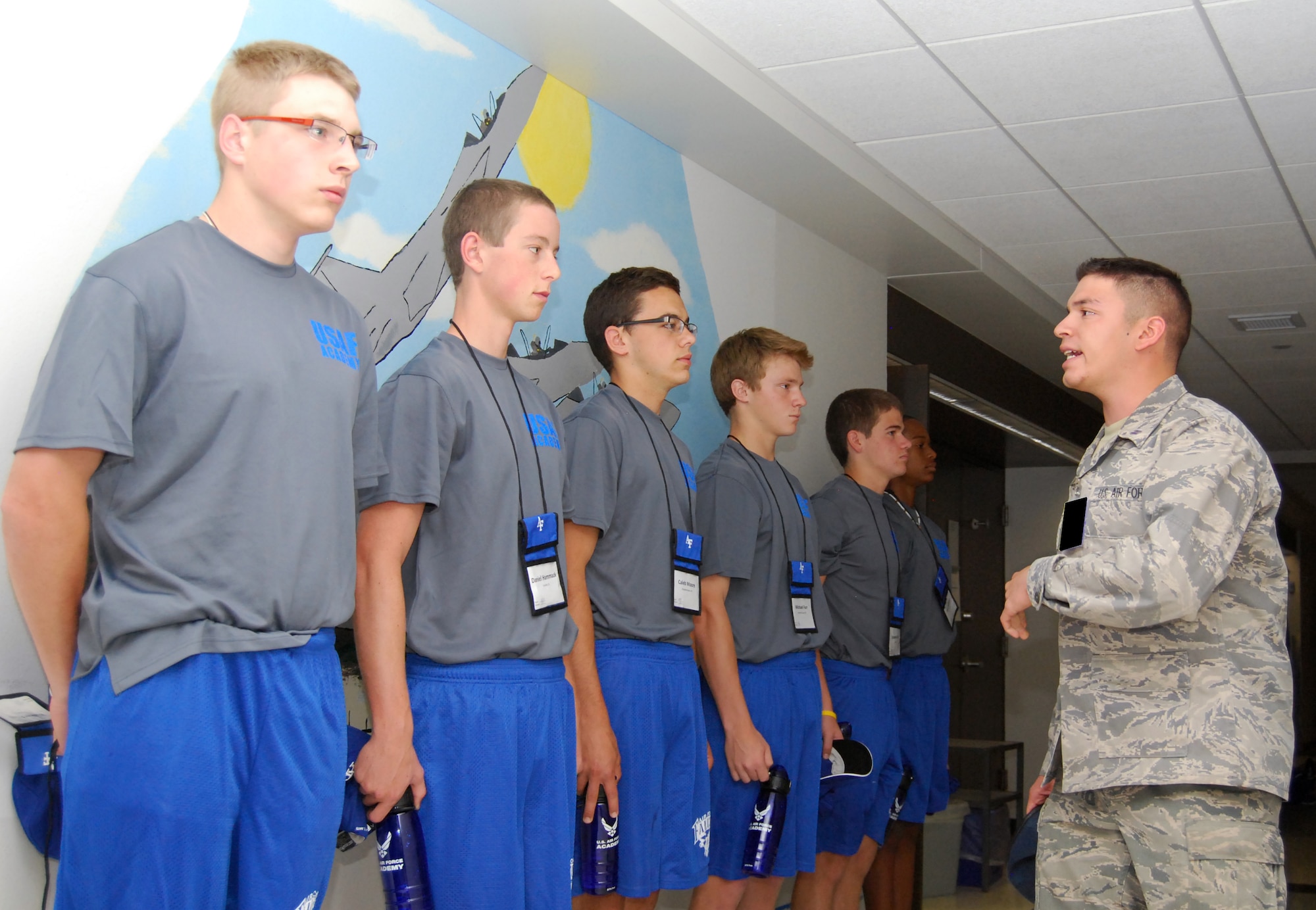 Cadet 2nd Class Bryant Mateus, right, motivates high school students during the first full day of Summer Seminar at the Air Force Academy June 7, 2011. The Academy offers three such seminars between graduation and inprocessing to approximately 1,100 high school juniors and seniors per year. Cadet Mateus, one of the Summer Seminar element leaders, is assigned to Cadet Squadron 17. (U.S. Air Force photo/Don Branum)
