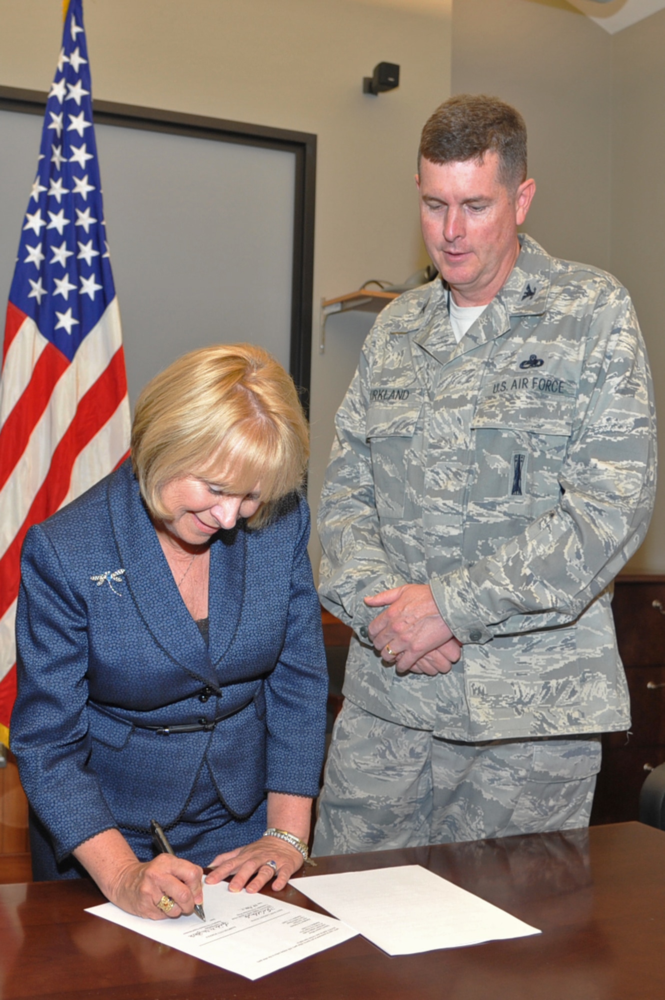Dr. Linda Shifflette, Hampton City Schools superintendent, and Col. Donald Kirkland, 633d Air Base Wing commander, sign an agreement with the school district at Langley Air Force Base, Va., June 7, 2011. Langley AFB will provide approximately 20 unit mentors and tutors to more than 30 Hampton City schools. (U.S Air Force photo by Airman 1st Class Camilla Griffin/Released)