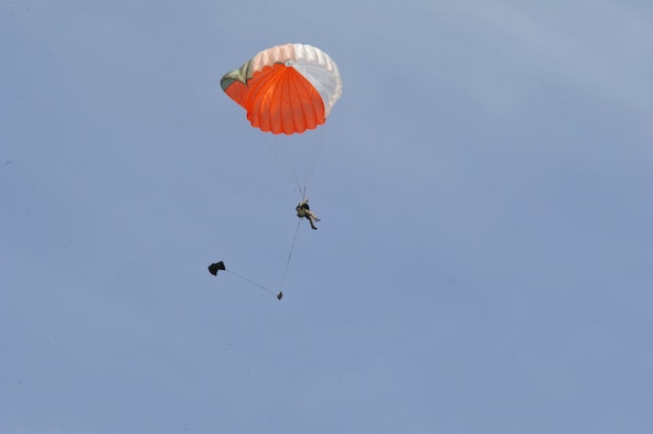 A survival, evasion, resistance and escape instructor from the 22nd Training Support Squadron performs a parachute demonstration for SERE students May 13, 2011, at Fairchild Air Force Base, Wash. The demos show students the characteristics of the C-9 Static line parachute and allow students to see firsthand techniques they've learned. This parachute was previuosly packed by the 336th Aircrew Flight Equipment shop and signifies all the hardwork that went into the preparation. (U.S. Air Force Photo/Tech. Sgt. J.T. May III) 