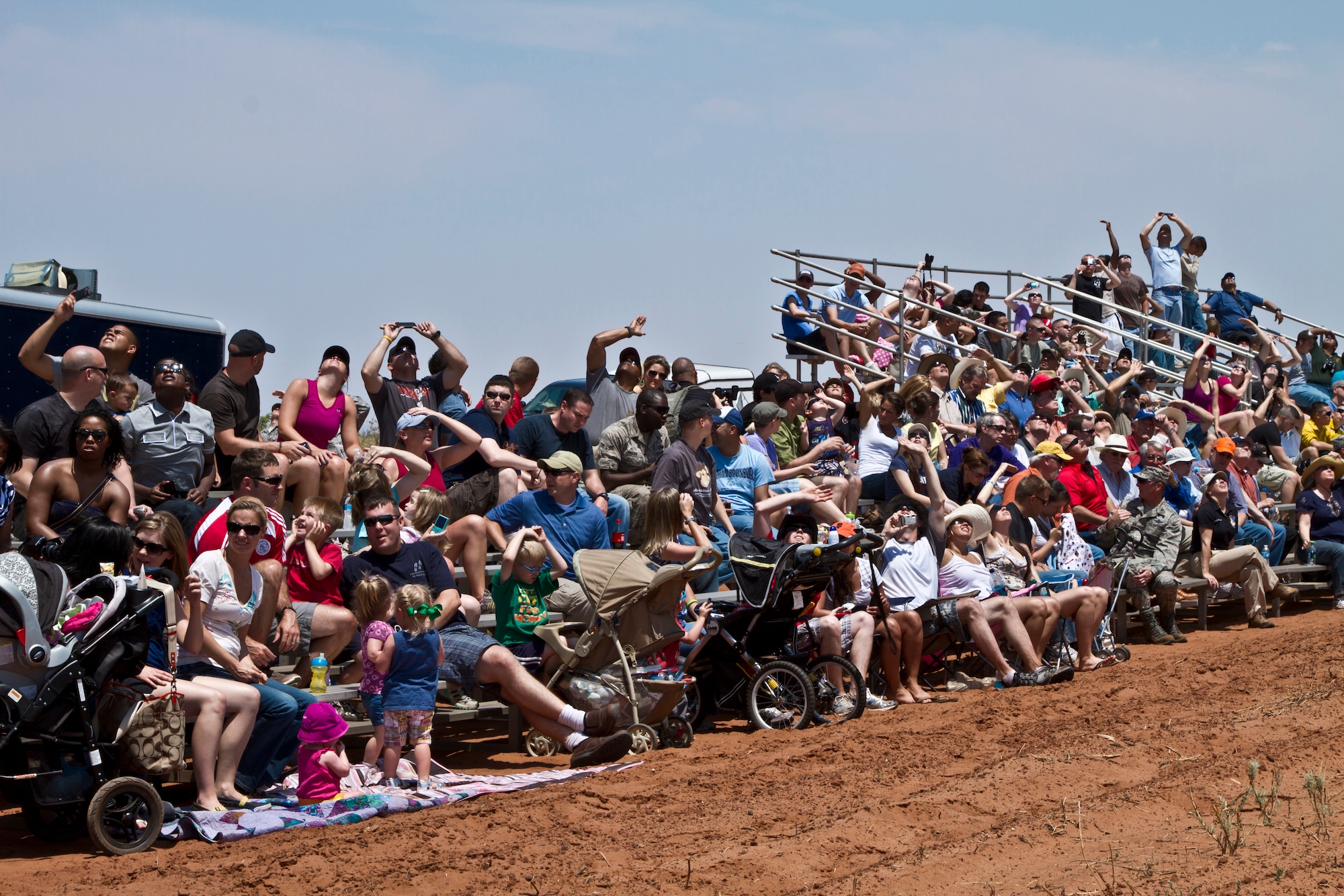 The crowd of around 600 people looks to the sky to view an aerial demonstration as part of the 27th Special Operations Wing Capabilites Exercise, June 4, 2011 at Melrose Air Force Range.  The CAPEX is an annual exhibition of the 27 SOW's many special operations aircraft and missions for Cannon Airmen and their families.  (U.S. Air Force photo by 2nd Lt. Stephanie Strine)(RELEASED)