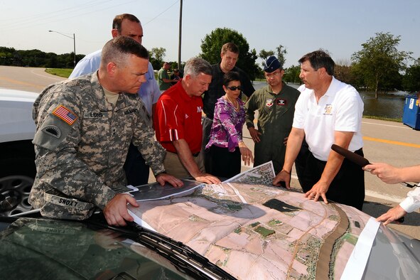 Army Corp of Engineers Maj. Gen. Judd Lyons, Governor Dave Heineman, Bellevue Mayor Rita Sanders, 55th Wing commander Brig. Gen. Donald Bacon and other officials look over a satellite map of the Missouri river and the corresponding metropolitan areas that could see heavy damages if the levee's were to fail at Hayworth Park in Bellevue, Neb. (U.S. Air Force photo by Josh Plueger/Released). 

