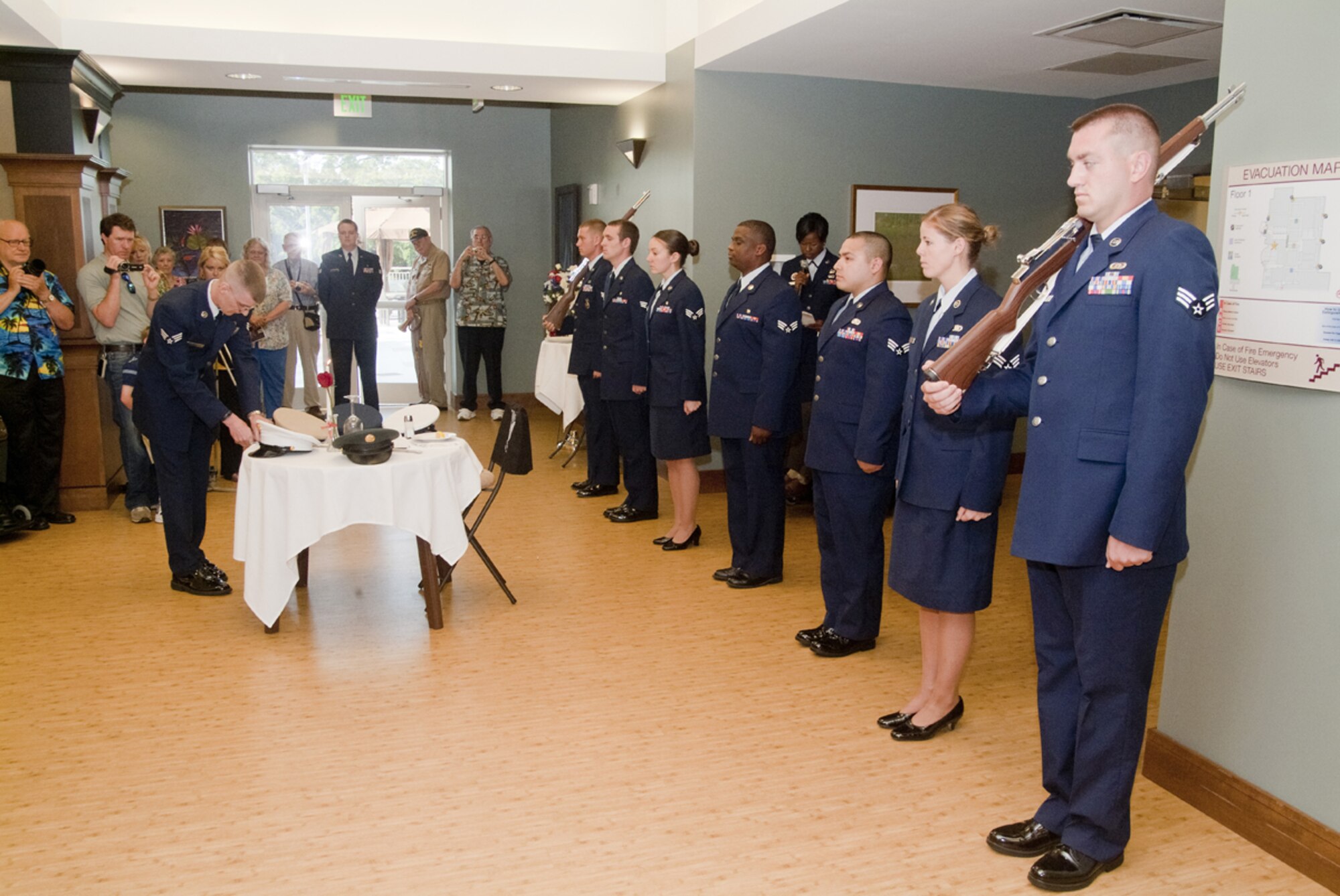 From left, Senior Airman Michael Phillips, 81st Security Forces Squadron, places
a sword in a sheath as Senior Airman Steven Showmaker, rifleman from the 81st
SFS; Senior Airmen Collin Guzak, 81st Aerospace Medicine Squadron; Casey
Lovelace, 81st Dental Squadron, and Lacedric Womack, 81st Medical Support
Squadron; Staff Sgt. Adrienne Russell George, ALS instructor, on microphone in
background; Senior Airmen Larry Moreno III, 81st Force Support Squadron;
Chelsie McCall, 81st SFS, and Bo Brauer, 85th Engineering Installation Squadron,
participate in the ceremony. The senior airmen are graduates of ALS Class 11-4.  (U.S. Air Force photo by Herb Welch)