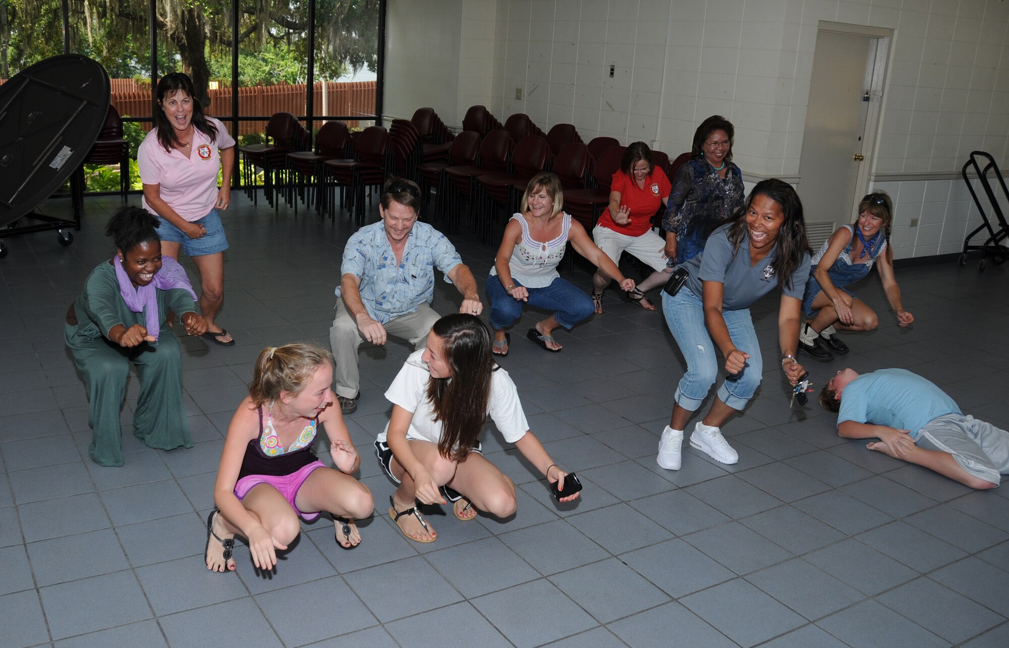336th Training Squadron personnel and family members do the “cha cha slide” at the 336th Training Squadron’s fais do-do at marina park Friday. Fais do-do is a name for a Cajun dance party.  (U.S. Air Force photo by Kemberly Groue)
