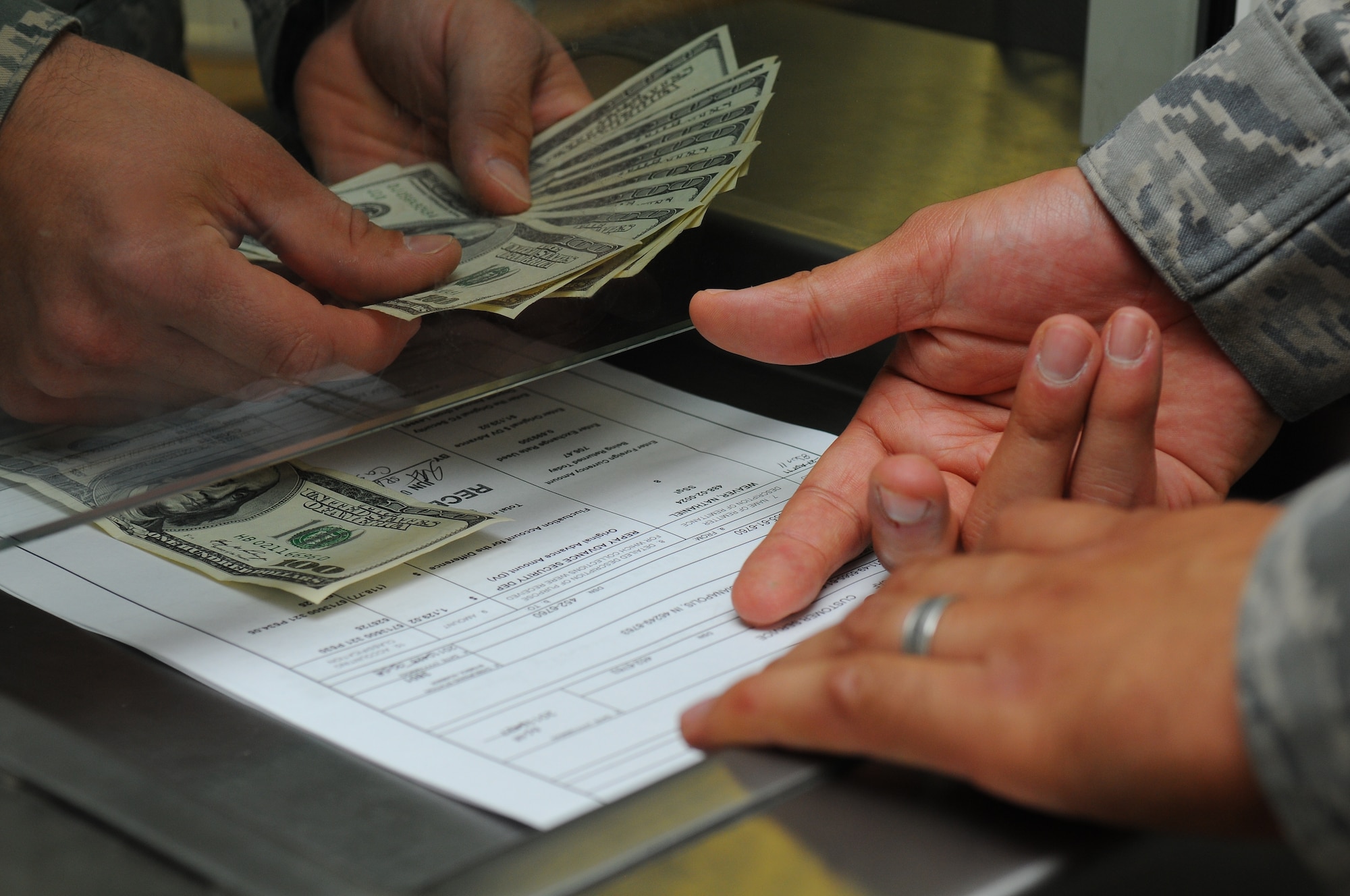 SPANGDAHLEM AIR BASE, Germany – A cashier cage worker counts money before handing it over to a customer at the cashier cage here June 9. The 52nd Comptroller Squadron services the base’s Airmen and families by funding vouchers, loans and other financial needs for the Spangdahlem Air Base community. (U.S. Air Force photo/Airman 1st Class Dillon Davis)