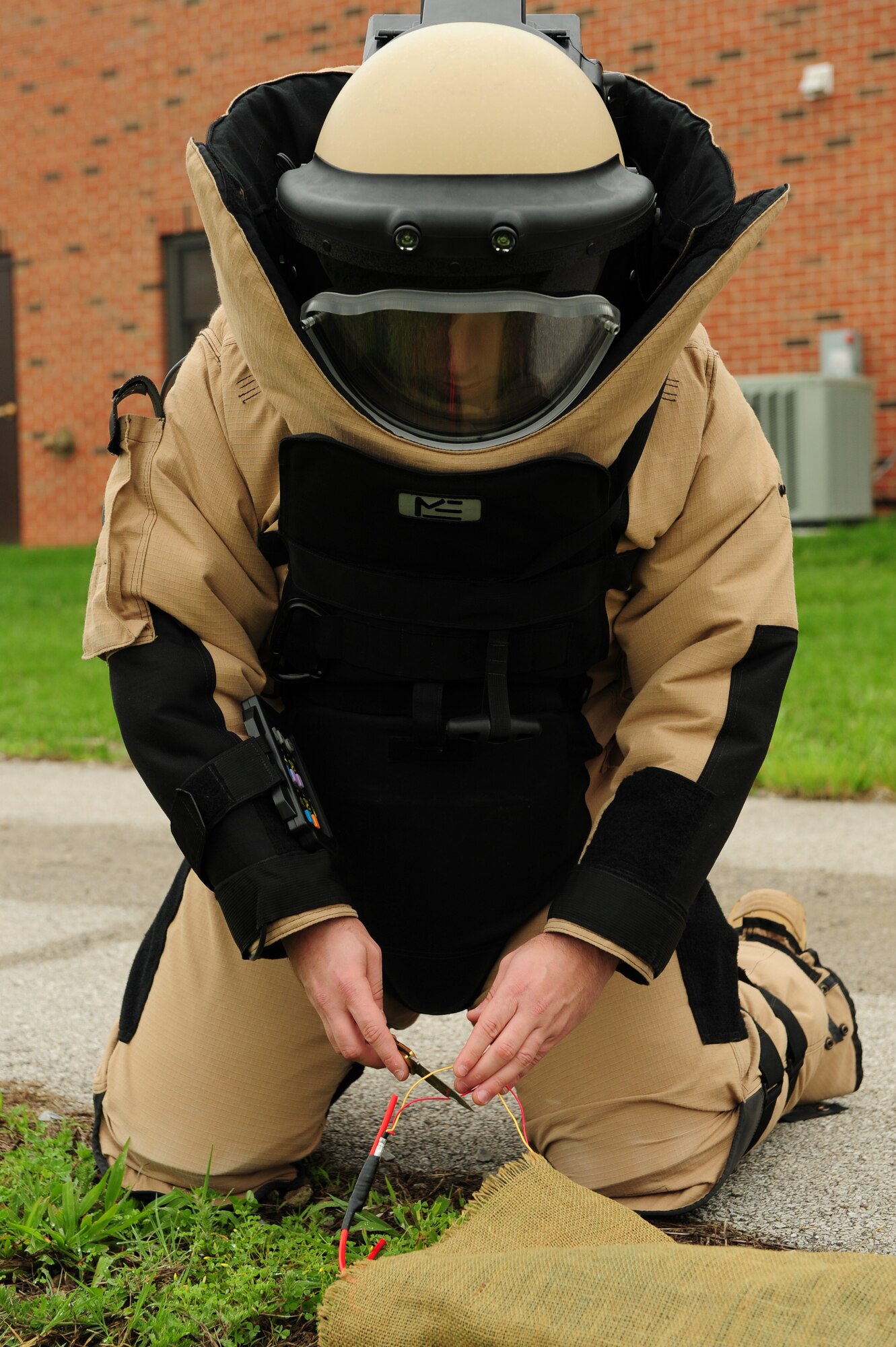Staff Sgt. Nathanael Lindsay practices dexterity while suited up in EOD gear. Sergeant Lindsay was presented a Bronze Star May 23 for actions in Iraq. (U.S. Air Force photo/Staff Sgt. Teresa M. Jennings) 