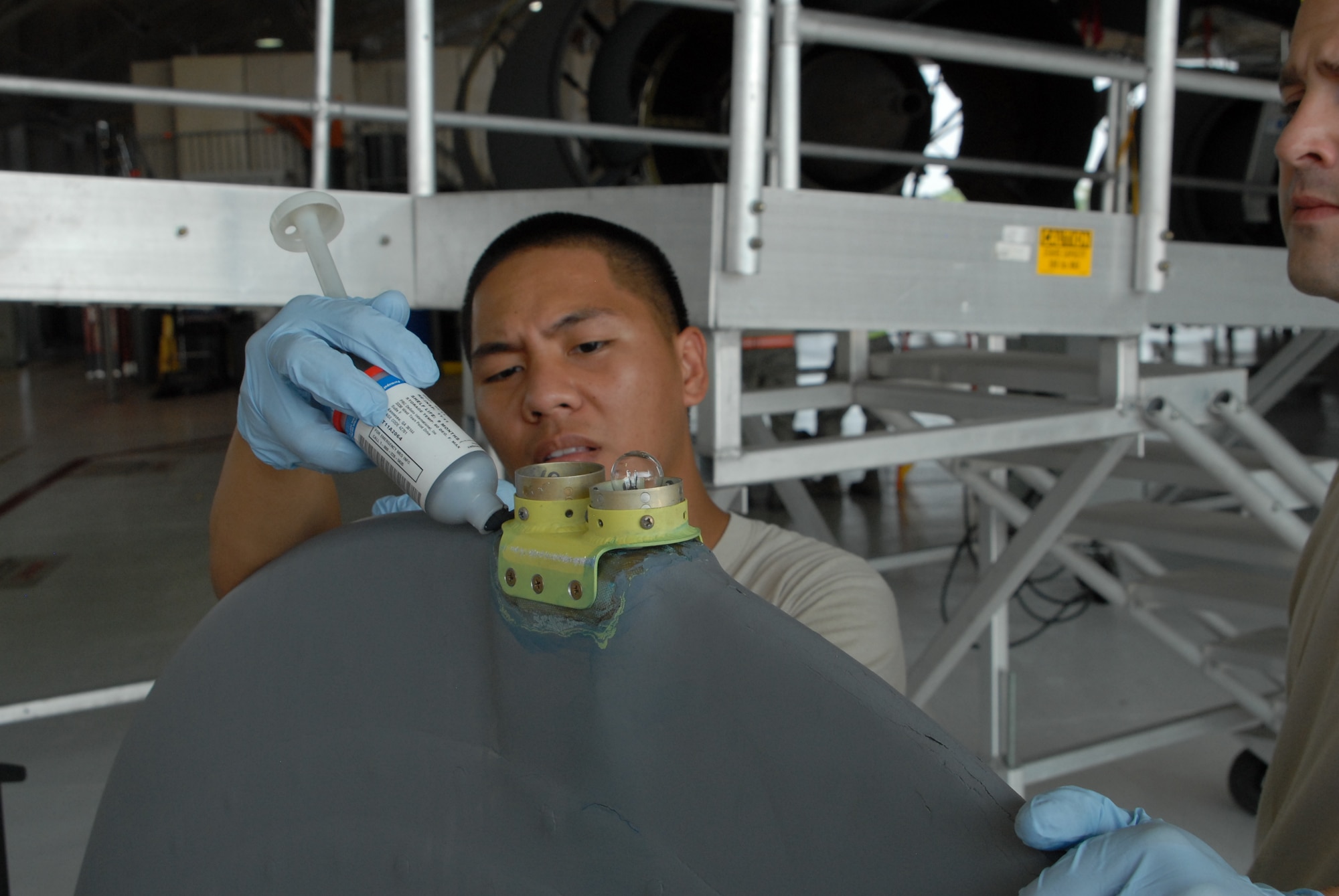 Staff Sgt. Kaohi Kainoa, an Aerospace Maintenance Journeyman, replaces the
navigational light bracket on the end of KC-135R tail cone at Scott AFB,
Ill. on June 6, 2011. Staff Sgt. Kainoa is assigned to the 906th Air
Refueling Squadron which is associated with the 126th Air Refueling Wing,
Illinois Air National Guard. (U.S. Air Force photo by Airman 1st Class
Dustin Clary)