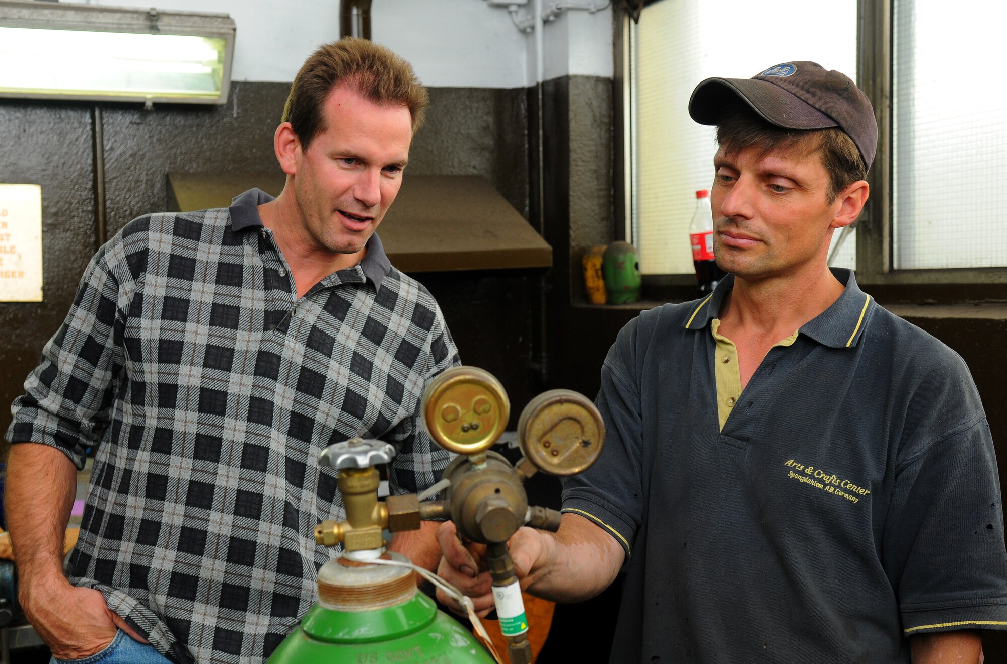 SPANGDAHLEM AIR BASE, Germany – Scott Livingston, left, U.S. Army Garrison Kaiserslautern Safety Team civilian contractor, learns how to adjust oxygen pressure from welding class instructor Max Baer, 52nd Force Support Squadron civilian contractor, at the auto skills center here June 8. Welding classes are offered monthly at Spangdahlem’s auto skills center. (U.S. Air Force photo/Airman 1st Class Dillon Davis)