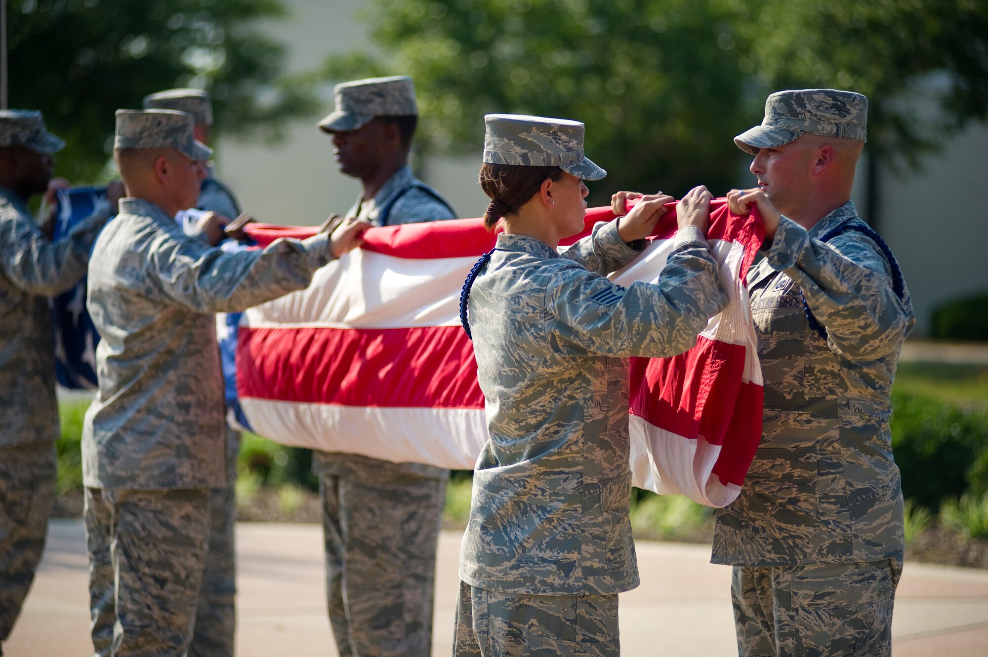 From left, Tech. Sgt. John Benavidez, 332nd Training Squadron; Staff Sgts. Lamar Gardner, 334th TRS, and Melissa Keith, 336th TRS; and Tech. Sgt. Kerry Holmes, 335th TRS, are some of the military training leaders who folded the flag during the 81st Training Wing’s formal retreat Friday. Tuesday is Flag Day, a national celebration of the history of the American flag and a time to remember proper etiquette for its display.  (U.S. Air Force photo by Adam Bond)