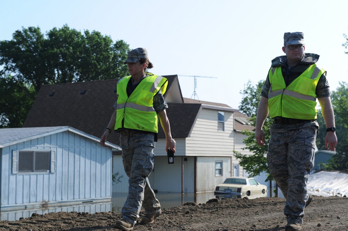 FORT PIERRE, S.D. - South Dakota Air National Guard Tech. Sgt Kodi Ingle, native of Chamberlain, a weather technician with the 114th Fighter Wing, monitors the Fort Pierre berm with Airmen 1st Class Spencer Daniels, native of Canton, a hydraulics technician with the 114th FW June 6, 2011. In addition to maintaining levee security, personnel and equipment are in place to provide quick reaction forces for levee reinforcement if needed. Water levels continue to rise along the Missouri River as the Oahe Dam releases a historic 150 thousand cubic feet per second out of its gates today. (SDNG photo by Spc. Manda Walters)(RELEASED)