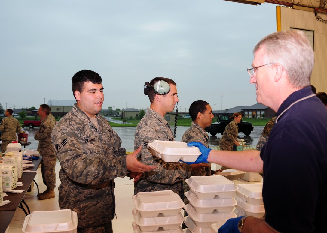 Members of the 914th Airlift Wing Chief's Group serve up barbecued chicken at the 5th annual Chief's Group Chicken BBQ fundraiser June 4, 2011 Niagara Falls Air Reserve Station, NY. The annual chicken BBQ raises money for the Chiefs Group Scholarship Fund. (U.S. Air Force photo by Senior Airman Jessica Snow)