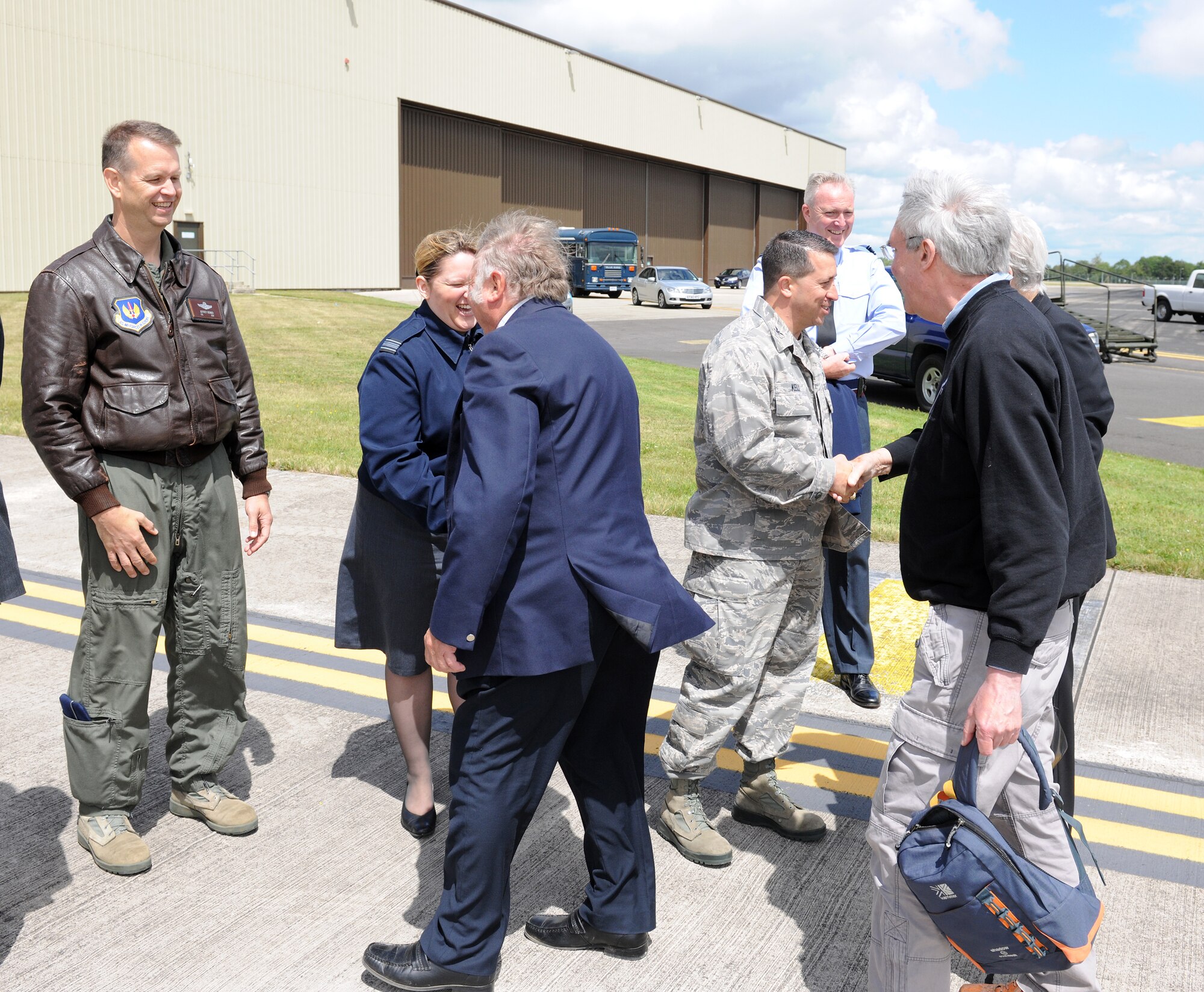 (From left, in uniform) Col. Jeffrey Renner, 422nd Air Base Group commander, Sqn. Ldr. Carrie-Anne Rossi, RAF commander RAF Fairford, and Col. Brian Kelly, 501st Combat Support Wing commander, greet local civic leaders and welcome them to RAF Fairford. The civic leaders received a tour of RAF Fairford and briefings regarding the mission of RAF Fairford and the 501st CSW. (U.S. Air Force photo/1st Lt. Brian Maguire)