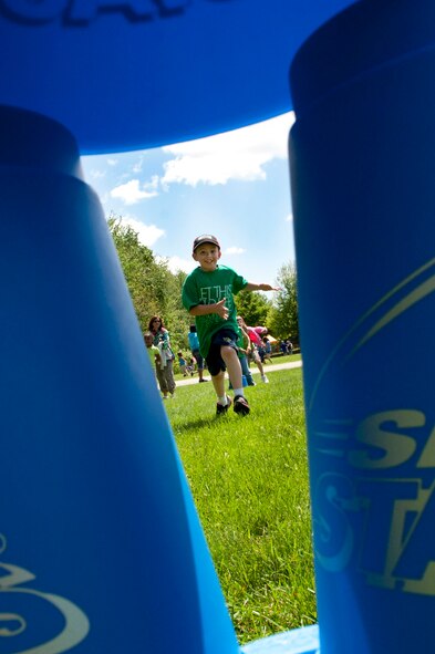 HANSCOM AIR FORCE BASE, Mass. – Hanscom Primary School third grader Andrew Coody races to the stackable cones during the school’s field day at the base soccer fields June 3. The students took part in many games and activities during the special day. (U.S. Air Force photo by Mark Wyatt)