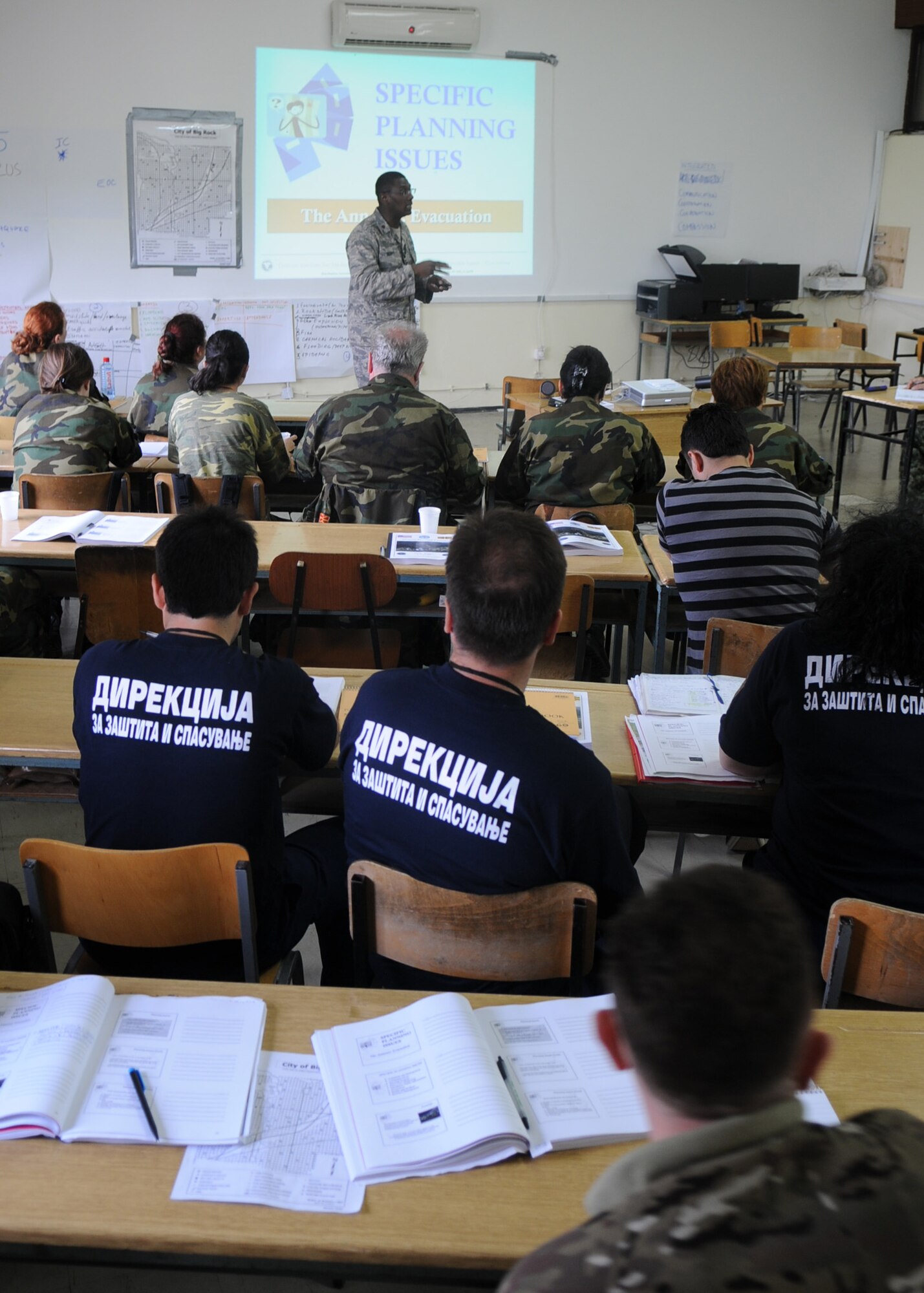 CAMP PEPELISHTE, Macedonia – Maj. Alvin Scott, U.S. Northern Command liaison officer to U.S. Transportation Command Surgeon General and a Defense Institute for Medical Operations instructor, teaches students from multinational partners about priorities to supply for a simulated response and recovery effort June 8 . This was part of the 2011 Medical Training Exercise in Central and Eastern Europe, or MEDCEUR 11, an annual, Chairman of the Joint Chiefs of Staff-sponsored regional and multilateral exercise, held in the spirit of NATO’s Partnership for Peace. Thirty-nine students from Macedonia, Slovenia, Serbia, Bosnia and Herzegovina, and Montenegro attended the course. (U.S. Air Force photo/Staff Sgt. Nadine Barclay)
