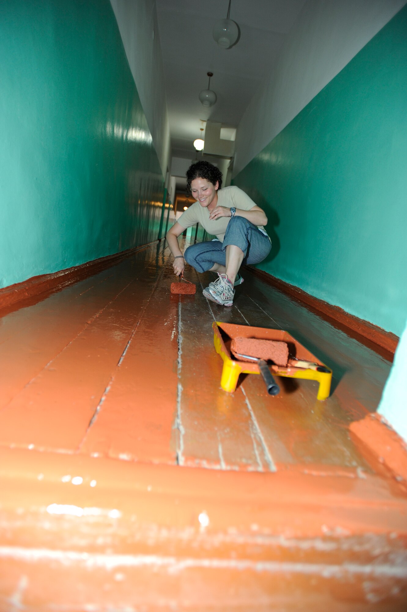 NIZNE-CHUISK VILLAGE, Kyrgyzstan -- Tech. Sgt. Rebecca Stadler, 376th Expeditionary Force Support Squadron Information, Trips and Tours and Marketing quality assurance, touches up the floor at the Nizne-Chuisk Village school during a Manas Area Benefit Outreach Society visit June 7.  Sergeant Stadler and other MABOS representatives from the Transit Center at Manas visited the "Niz Village"to help school officials prepare for the upcoming school year.   (U.S. Air Force photo by Master Sgt. Jerome C. Baysmore)