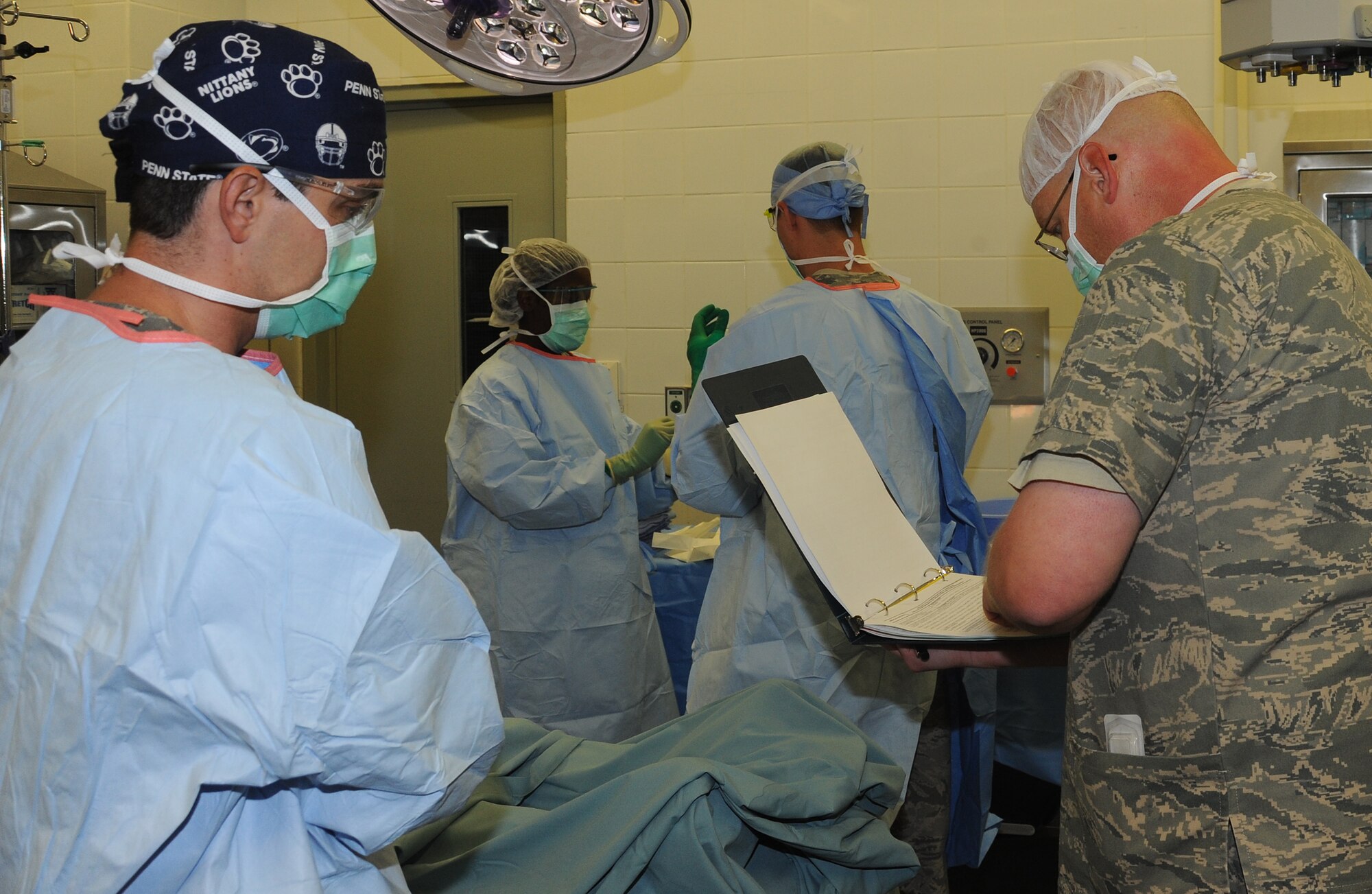 Maj. John Mansuy, operating room nurse, goes over patient records with Dr. (Maj) Gustavo Lopes, general surgeon, prior to surgery at an undisclosed location in Southwest Asia, May 31. (U.S. Air Force photo/Staff Sgt. Liliana Moreno)                          