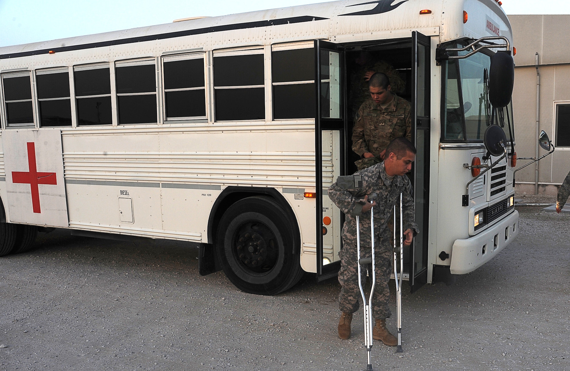 Spc. Peter Tong,  Intra Theater Care Program patient, steps off the bus prior to departing on a mission  to Germany to continue rehabilitation treatment. Missions happen four times a week, the extent of the injury is what determines if the patients go back downrange or home for further medical treatment. (U.S. Air Force photo/ Staff Sgt. Liliana Moreno)         