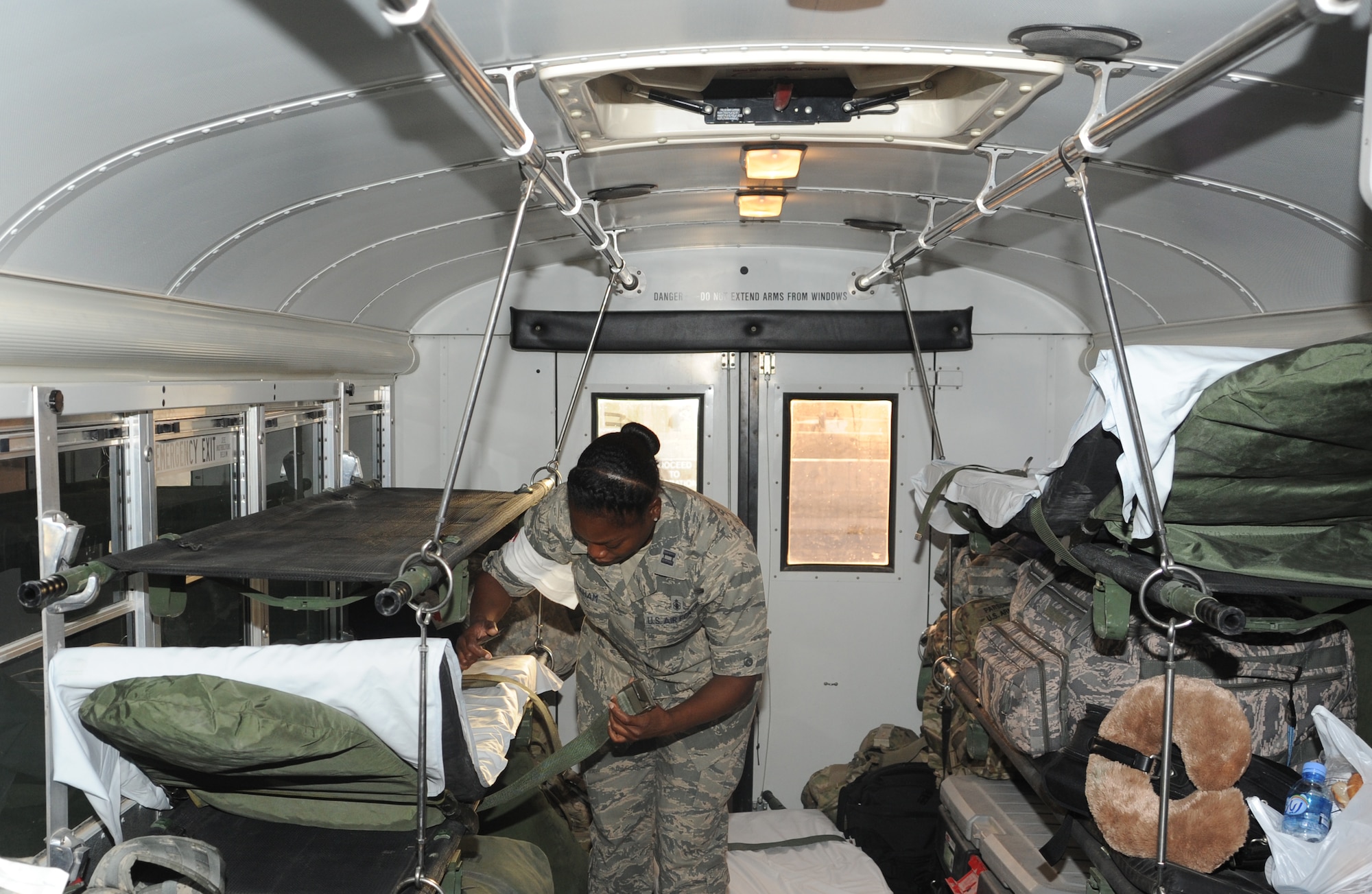 Capt. Sparkle Graham, 379th Expeditionary Medical Group critical care nurse, preps the medical evacuation bus for patients being transferred to the flightline to go back downrange or home for further medical treatment at an undisclosed base in Southwest Asia, May 21. (U.S. Air Force photo/Staff Sgt. Liliana Moreno)     