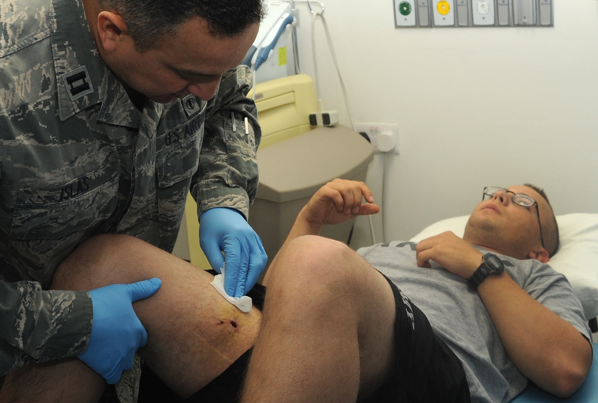 Dr. (Capt.) Felix Islas provides therapy to a patient with a gunshot wound in his leg. Doctor Islas is a physical therapist with the 379th Expeditionary Medical Group. (U.S. Air Force photo/Staff Sgt. Liliana Moreno)                            