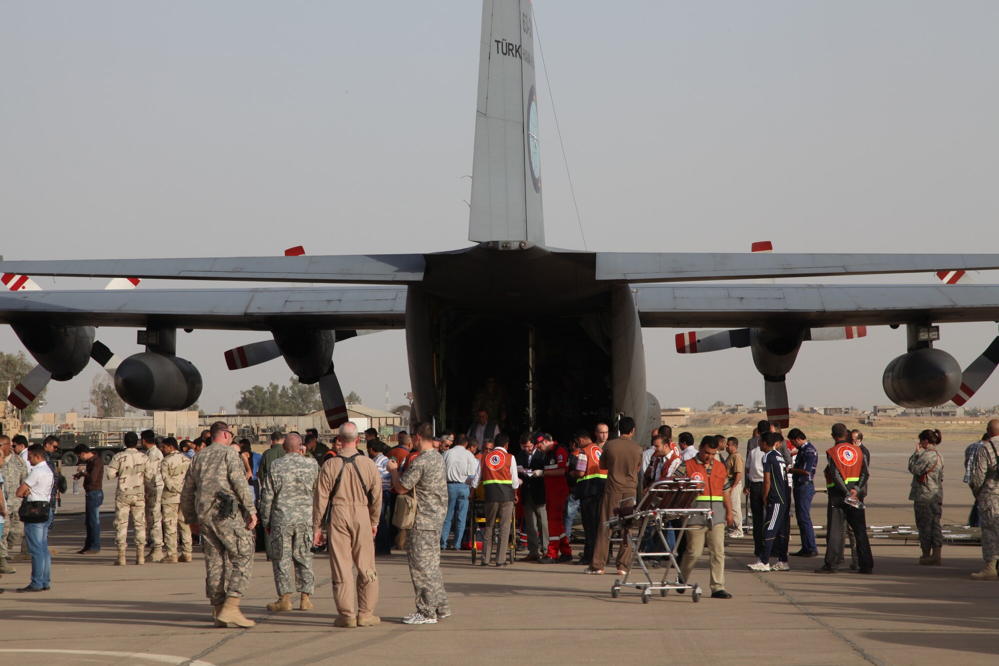 KIRKUK REGIONAL AIR BASE, Iraq – Medical crews prepare to load patients onto a Turkish C-130 after they were cared for by the medical staff at the 321st Expeditionary Medical Squadron. Reports indicate 20 people were killed and nearly 80 people were injured when improvised explosive devices detonated near the police station in Kirkuk. The 321st EMEDS volunteered to help care for the wounded when civilian facilities were overwhelmed. (Courtesy photo)