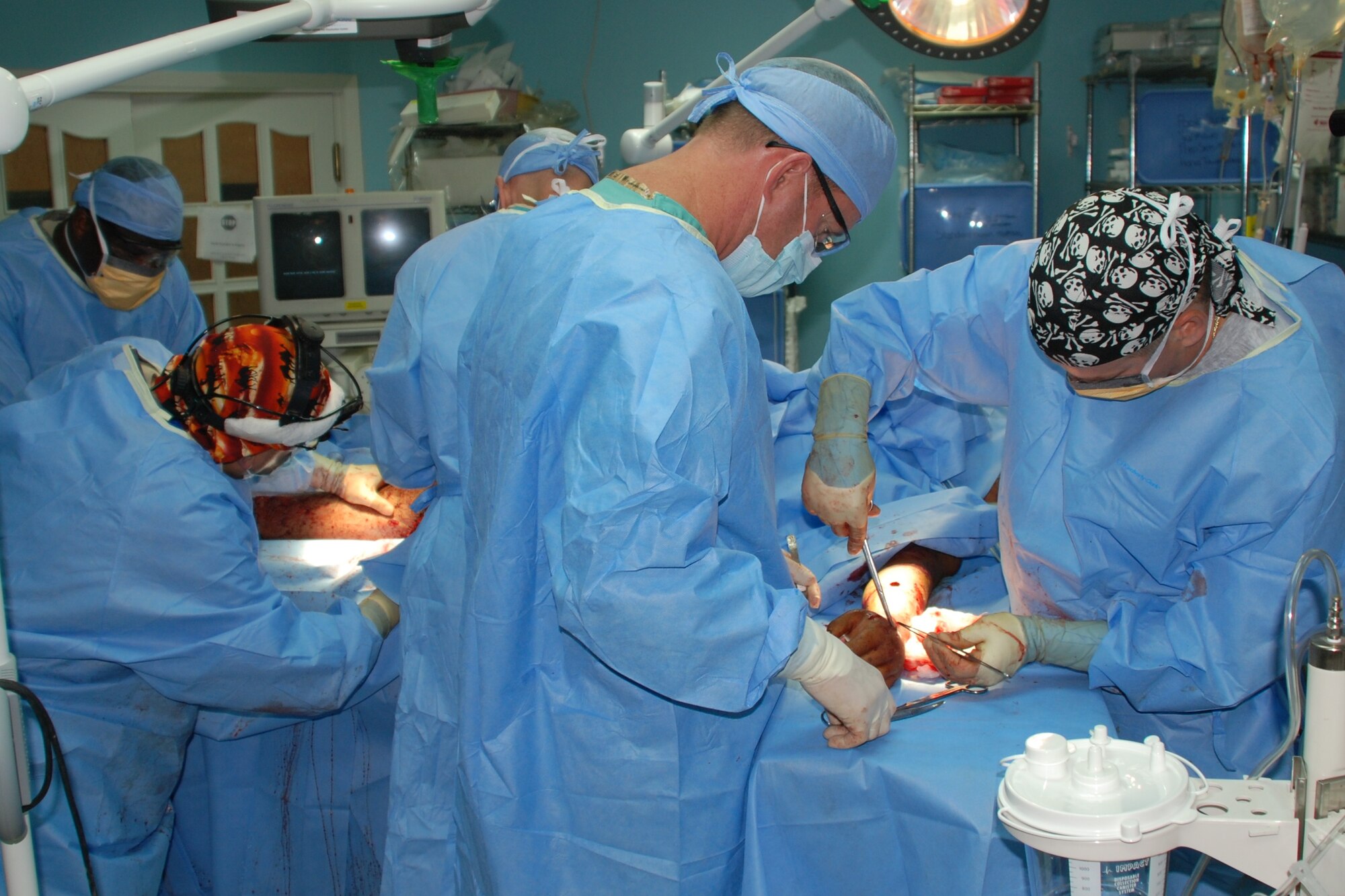 KIRKUK REGIONAL AIR BASE, Iraq – Medical teams with the 321st Expeditionary Medical Squadron remove shrapnel from a civilian patient brought to the base hospital May 19. Reports indicate 20 people were killed and nearly 80 people were injured when improvised explosive devices detonated near the police station in Kirkuk. The 321st EMEDS volunteered to help care for the wounded when civilian facilities were overwhelmed. (Courtesy photo)