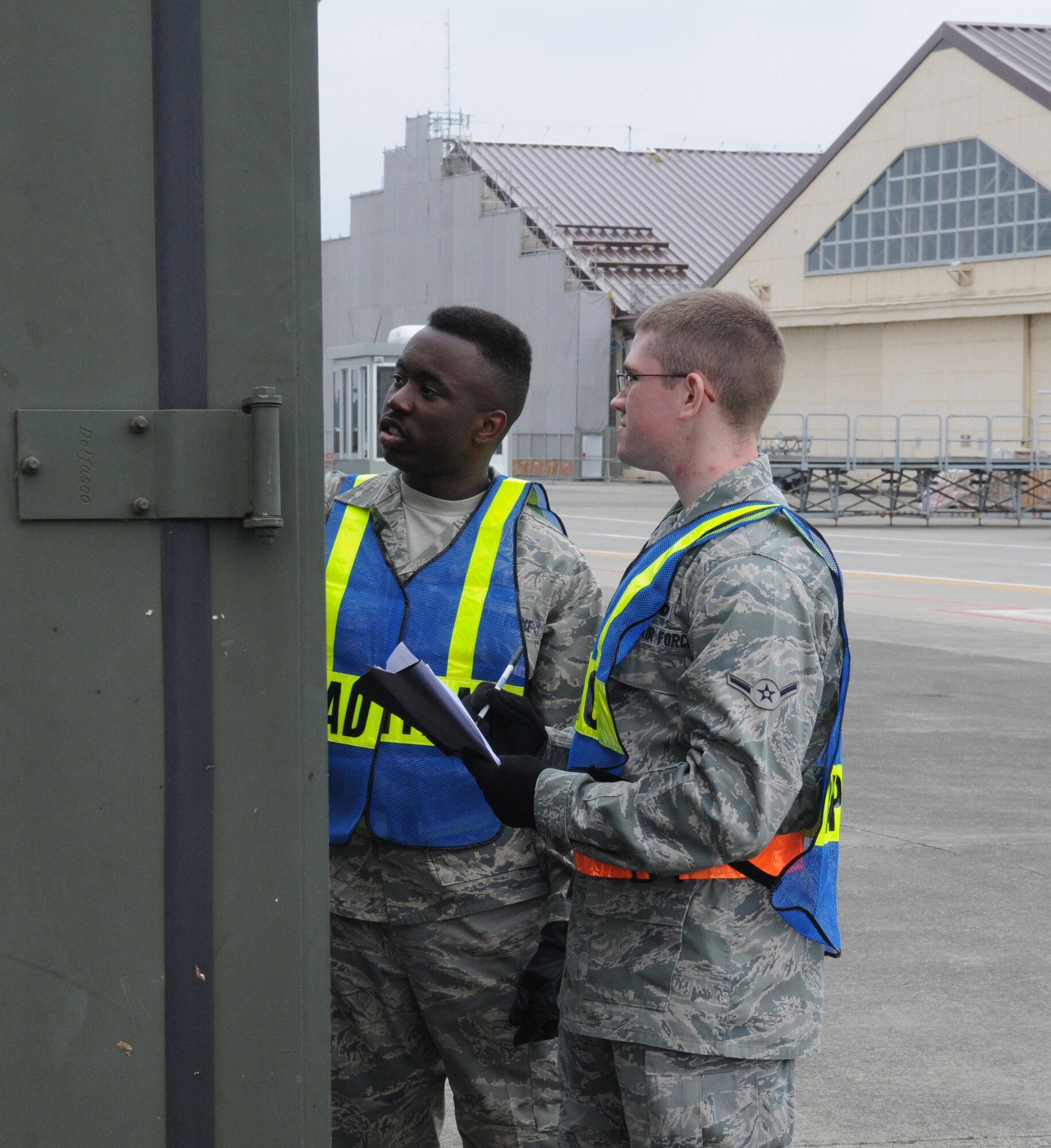 YOKOTA AIR BASE, Japan -- Airman 1st Class Jarrett Hunt (left) and Airman Brendon Johnson, 374th Maintenance Squadron aerospace propulsion apprentices, ensure their equipment is accounted for during a readiness exercise June 8, 2011, at Yokota Air Base, Japan. The goal of the exercise was to test Yokota's ability to respond appropriately and effectively to real world contingencies. (U.S. Air Force photo/Airman John D. Partlow)