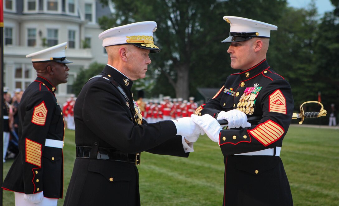 Commandant of the Marine Corps Gen. James F. Amos hands the sword of office to Sgt. Maj. of the Marine Corps Micheal Barrett during a relief and appointment ceremony at Marine Barracks Washington June 9, 2011. Barrett took charge as the 17th Sergeant Major of the Marine Corps as Sgt. Maj. Carlton W. Kent, the predecessor, relinquished his duties as senior enlisted advisor to the Commandant and retired from active service in the Marine Corps.