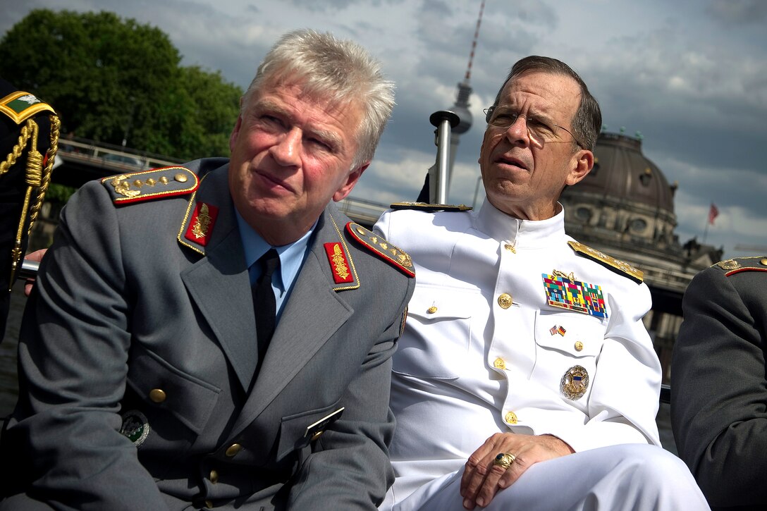 U.S. Navy Adm. Mike Mullen, chairman of the Joint Chiefs of Staff, and German Gen. Volker Wieker, chief of staff of the German Armed Forces, take a boat tour of Berlin on the Spree River, June 9, 2011. Mullen is on a seven-day trip visiting Egypt and Europe to meet with counterparts and leaders.