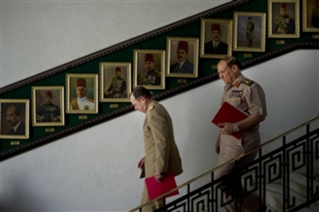 Chairman of the Joint Chiefs of Staff Adm. Mike Mullen departs the Egyptian Ministry of Defense with Chief of Staff of the Egyptian Armed Forces Army Lt. Gen. Sami Enan, in Cairo on June 8, 2011.  Mullen is on a seven-day trip visiting Egypt and Europe to meet with counterparts and leaders.  