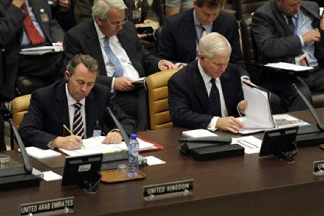 Secretary of Defense Robert M. Gates sits next to the United Kingdom's Secretary of State for Defense Liam Fox during the NATO and non-NATO ISAF contributing nations meeting during the NATO formal Defense Ministerial in Brussels, Belgium, on June 9, 2011.  