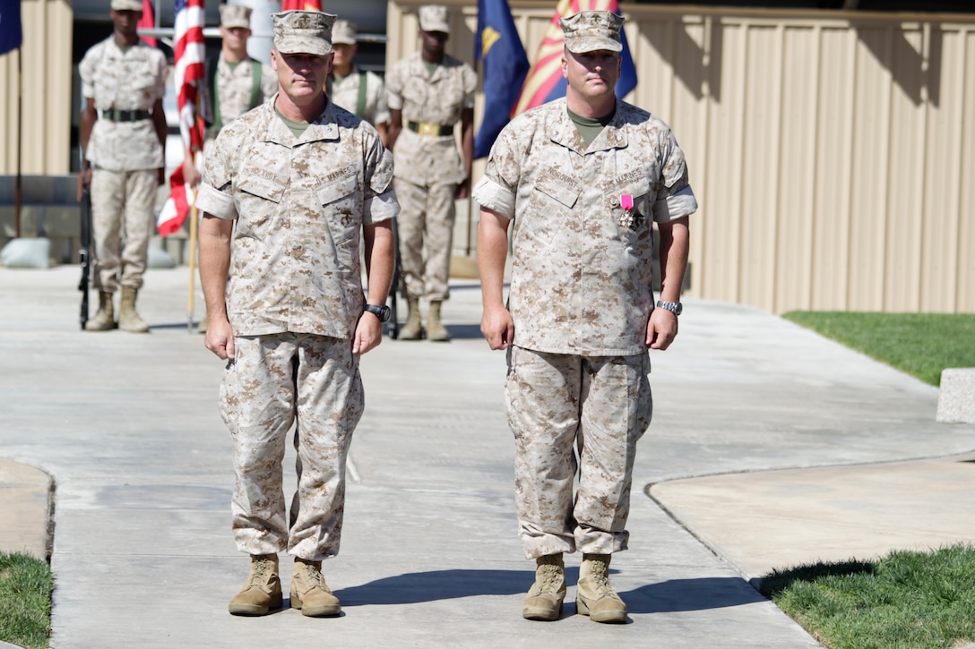 Lieutenant Col. Brent Norquist and his retiring officer, Brig. Gen. H. Stacy Clardy, stand at attention during Norquist’s retirement ceremony at the Combat Center flag pole June 10, 2011.::r::::n::