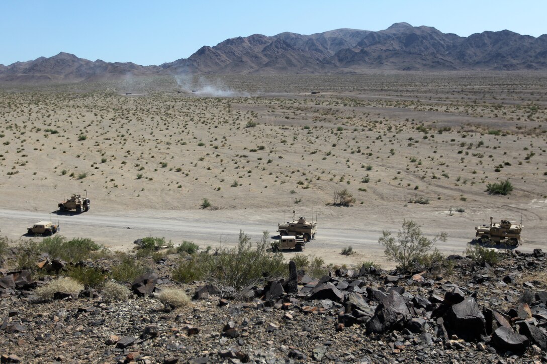 Vehicles with Motor Transportation Company, Marine Wing Support Squadron 371, engage and entrenched enemy position after an ambush during Enhanced Mojave Viper convoy training at Combat Center range 205 June 10, 2011.