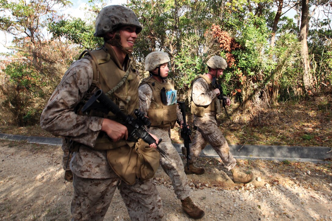 5th Air Naval Gunfire Liaison Company, III Marine Expeditionary Force Headquarters Group, III MEF, Marines travel to their next objective during the ANGLICO Basic Course on Camp Hansen June 10. The four-week long course tested the Marines’ ability to accomplish ANGLICO’s mission.