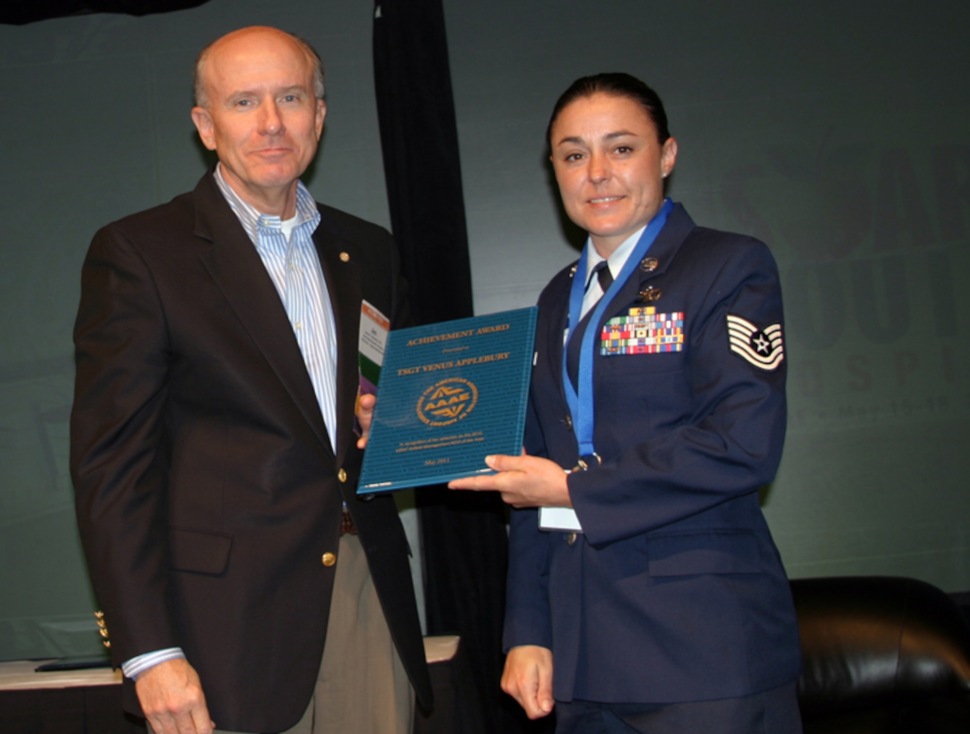 NELLIS AIR FORCE BASE, Nev. – Jim Bennett, American Association of Airport Executives chairman, presents Tech. Sgt. Venus Applebury, 57th Operations Support Squadron deputy airfield manager, the award for 2010 U.S. Air Force Airfield Management NCO of the Year during their annual meeting in Atlanta. Sergeant Applebury was also presented the award from Maj. Gen Bret Williams, U.S. Air Force deputy chief of staff for operations, plans and requirements, last May during the Air Force Airfield Operations Conference at Keesler Air Force Base, Miss.