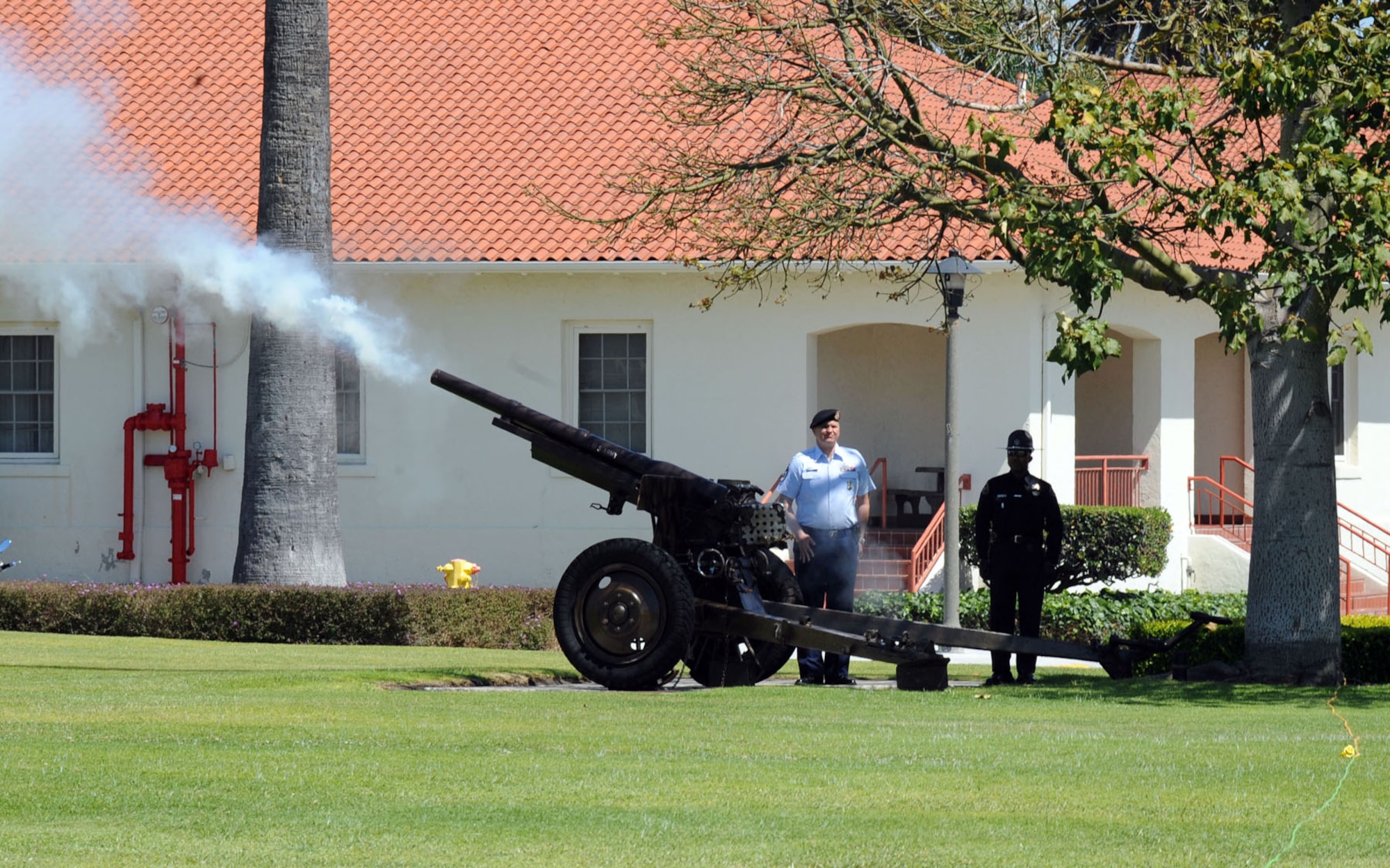 As Lt. Gen. Ellen Pawlikowski assumes command from Lt. Gen. Tom Sheridan, one of Fort MacArthur's two ceremonial cannons fires. The Ceremonial Cannon Detail at Los Angeles AFB has the distinction of being one of the only organizations of its kind in the Air Force. The two French cannons were built in 1917 and 1918 respectively and are mounted on 1940 caissons. The cannons fire 75mm blank cannon shells. (Photo by Sarah Corrice)