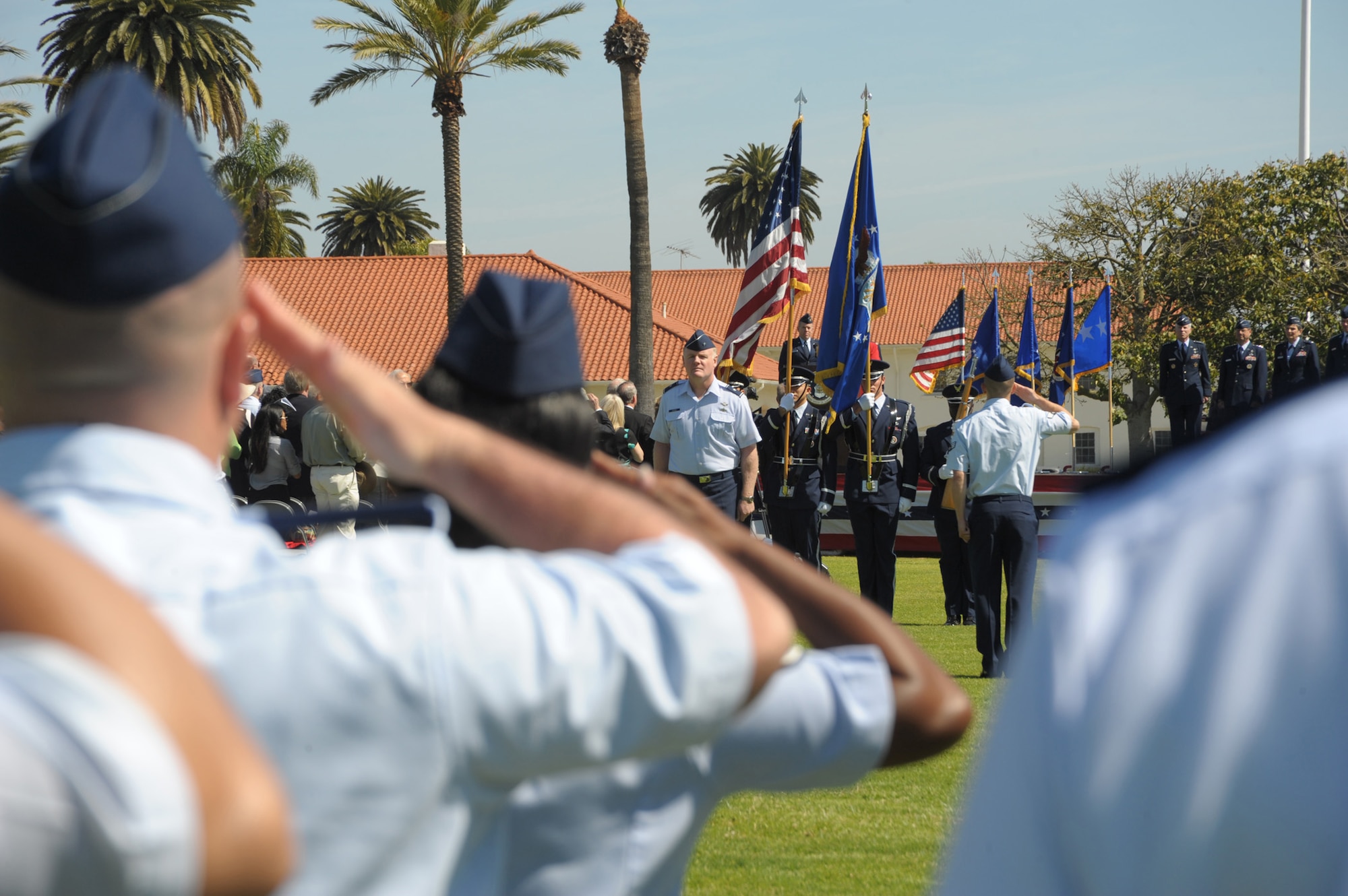 Airmen standing in formation salute the flag during the SMC change of command ceremony, June 3. Lieutenant Gen. Ellen Pawlikowski assumed command from Lt. Gen. Tom Sheridan at a ceremony officiated by Gen. William Shelton, Air Force Space Command commander, and attended by more than 500 family, friends, community leaders and SMC personnel. (Photo by Joe Juarez)