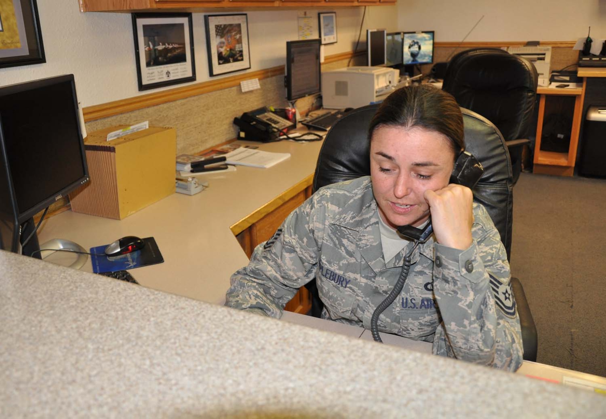 NELLIS AIR FORCE BASE, Nev. -- Tech. Sgt. Venus Applebury, 57th Operations Support Squadron deputy airfield manager, answers a call June 10 at base operations. The American Association of Airport Executives recently recognized Sergeant Venus Applebury as the 2010 U.S. Air Force Airfield Management NCO of the Year during their annual meeting in Atlanta.