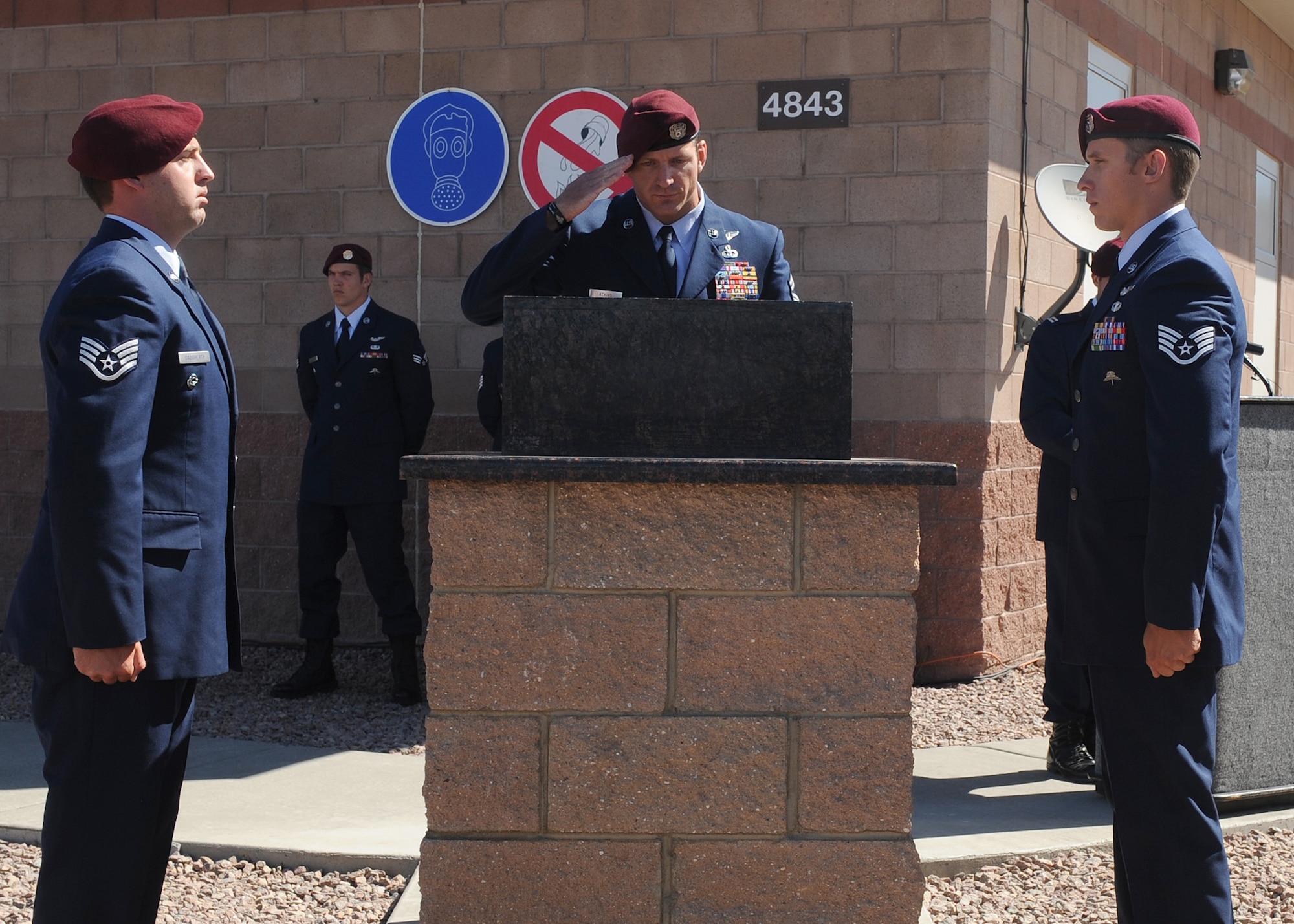 DAVIS-MONTHAN AIR FORCE BASE, Ariz. – Senior Master Sgt. Michael Atkins (middle), 48th Rescue Squadron, salutes a newly unveiled memorial plaque while Staff Sgt. Brandon Daugherty (left) and Staff Sgt. Brent Moore, both members of the 48th RQS, stand at attention here June 9. The memorial plaque honors Tech. Sgt. Michael Flores and Senior Airman Benjamin White, both pararescuemen from the 48th RQS, who were killed in the Pedro 66 crash in Afghanistan June 9, 2010