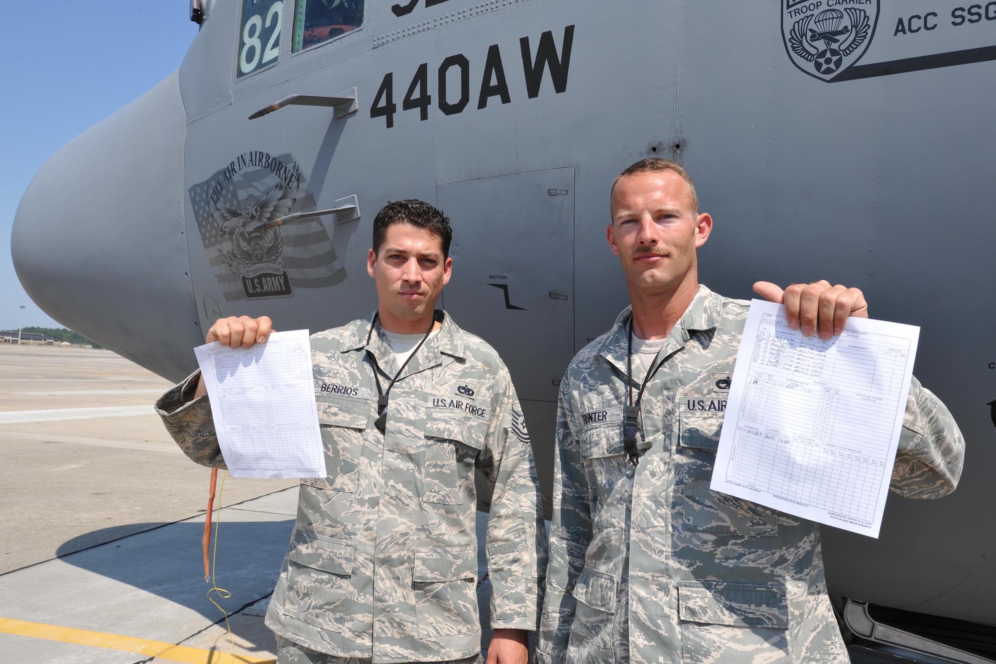 Tech. Sergeants Abner Berrios (left) and Alan Hunter display their letter perfect "black-letter initial" aircraft checklists at Pope Field, N.C. In an effort to set a positive example for the unit's newer crew chiefs and members, the two used their professional rivalry to try to out-work and out-inspect each other. The end result was the rarity of both crew chiefs obtaining discrepency free checklists. Both sergeants are crew chiefs with the 440th Airlift Wing. (U.S. Air Force photo/Staff Sgt. Peter Miller) 

