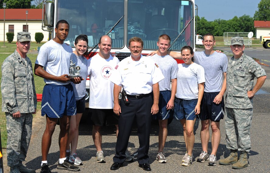 Lt. Col. Douglas Tippet, 2nd Civil Engineer Squadron commander, and Col. Scott Hoover, 2nd Mission Support Group commander, stand with the Airmen of the 2nd Contracting Squadron after the third annual Fire Muster on Barksdale Air Force Base, La., June 10. The Airmen of the 2 CONS won the fire muster and were presented with the 2011 Barksdale fire muster trophy. The 2nd Communication Squadron, 2nd Force Support Squadron, 2 CES and 2CONS competed against each other during the event. (U.S. Air Force photo/Airman 1st Class Micaiah Anthony)(RELEASED)