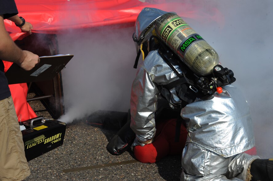 An Airman from the 2nd Force Support Squadron prepares to enter a confined space filled with smoke for the search and rescue event during the third annual Fire Muster on Barksdale Air Force Base, La., June 10.  Participants must crawl through a smoked-filled area and retrieve a 175-pound mannequin. This event simulates disorientation while searching for victims in a smoke-filled home or warehouse. (U.S. Air Force photo/Airman 1st Class Micaiah Anthony)(RELEASED)